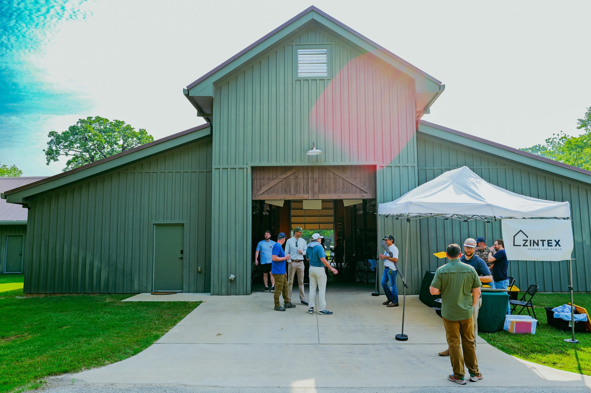 The range. A green barn, a tent, a gravel lot filling up.