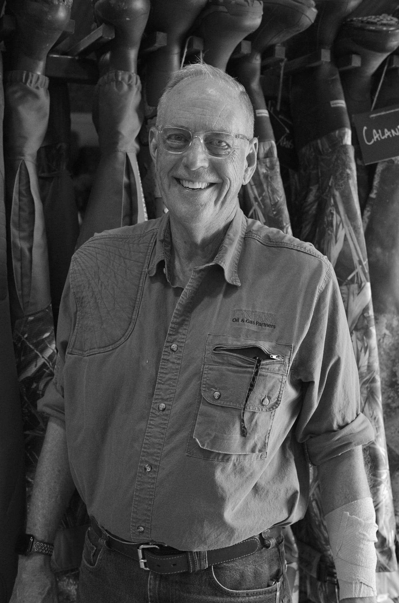 A portrait against the rack of camouflage jackets.