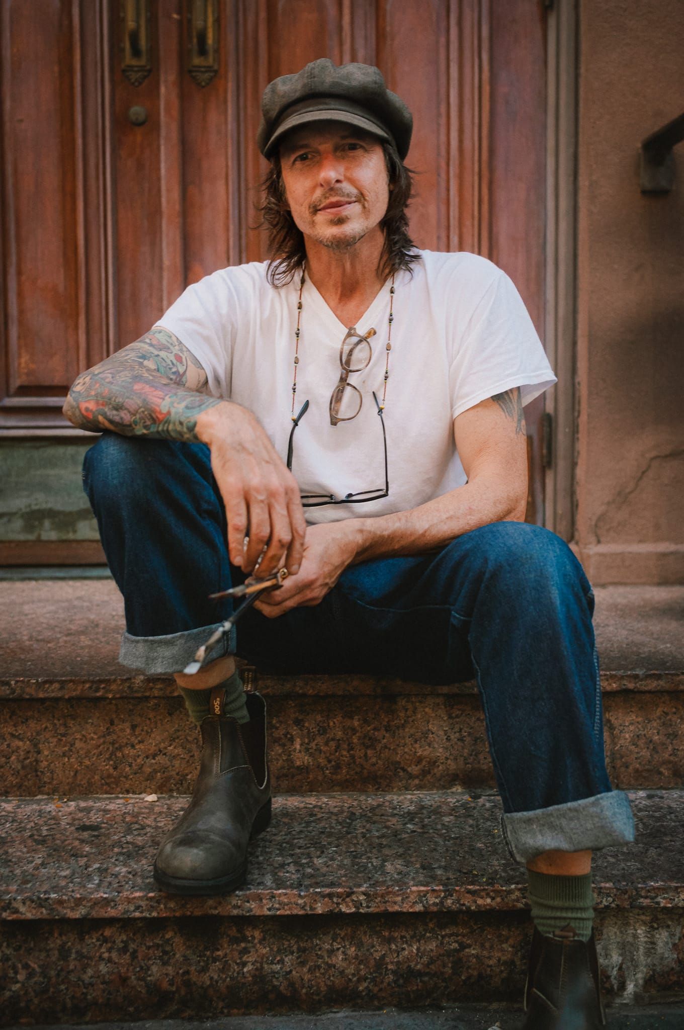 A painter seated on a Chinatown stoop
