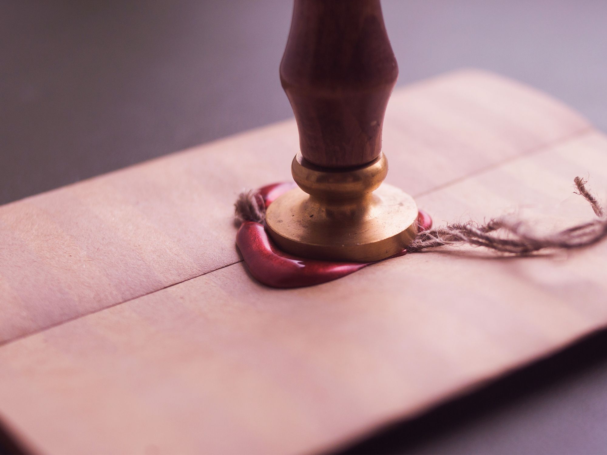 Pressing-wax-seal-on-message
