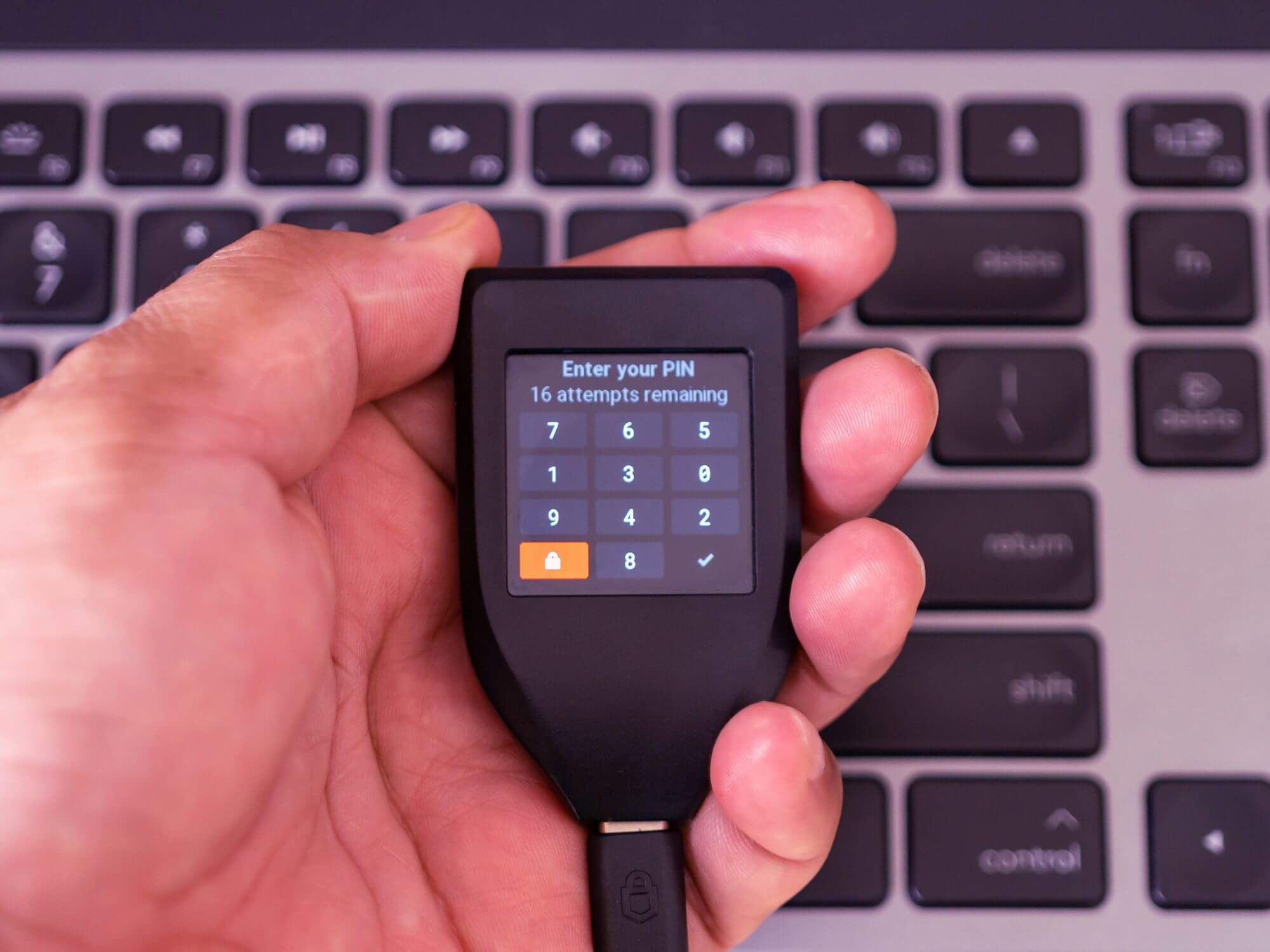 trezor-in-hand-showing-pin-screen