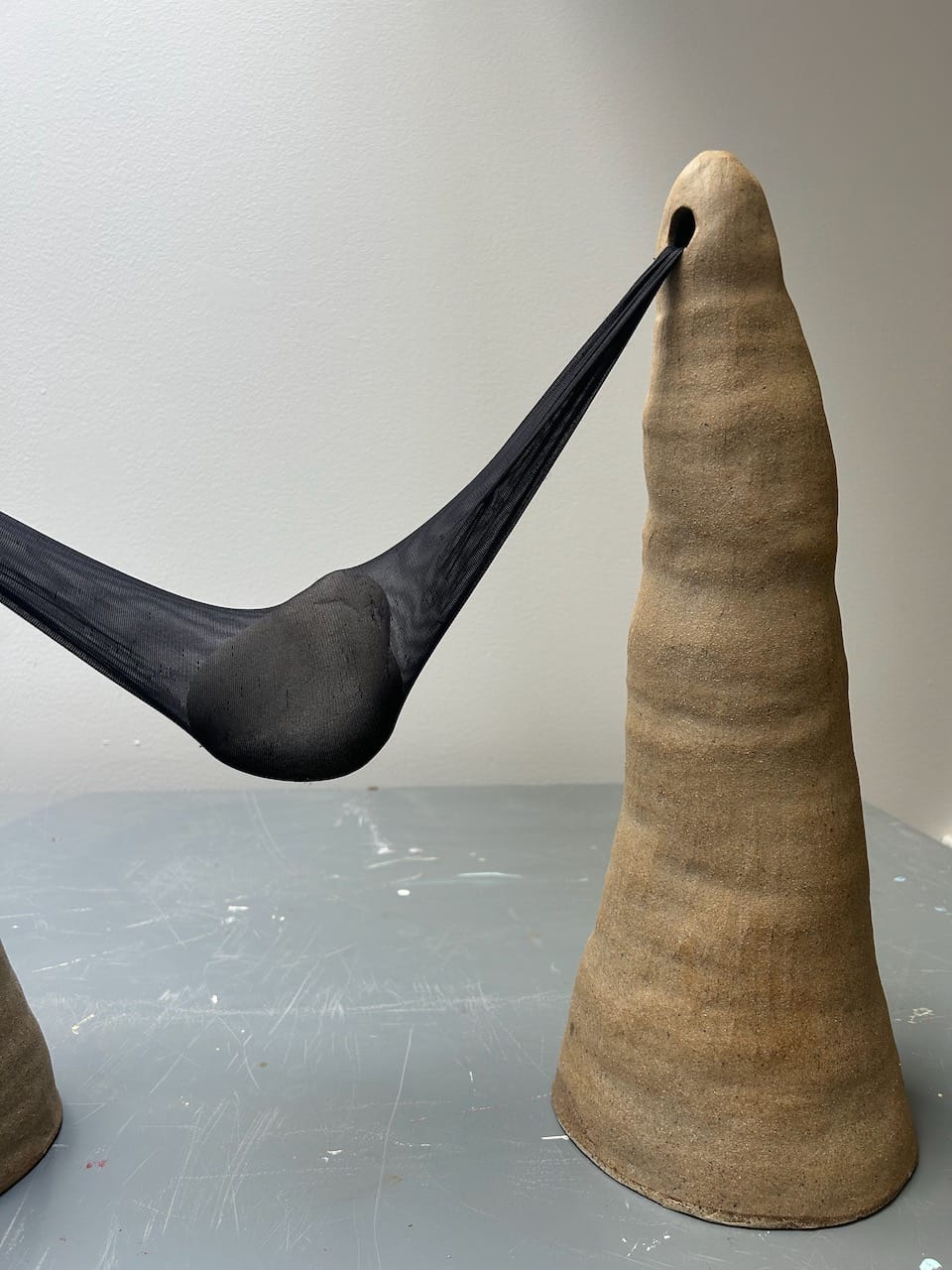 A closup of one of the lumpy clay cones holding the nylon