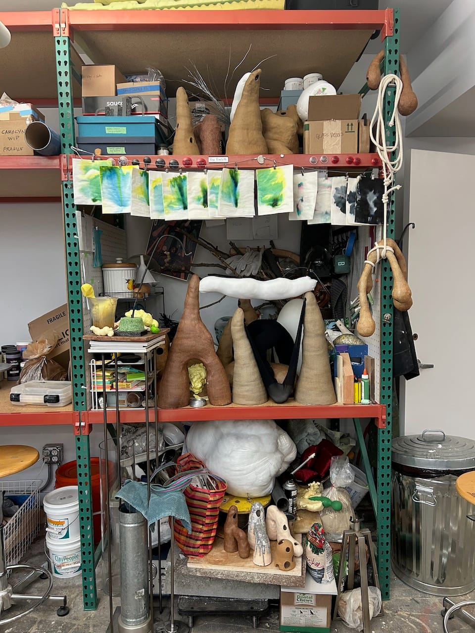 an extremely messy bench full of stuff such that you can't even see the desk surface or the back wall