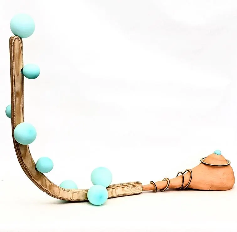 a sculpture made of wood, ceramics, and balloons