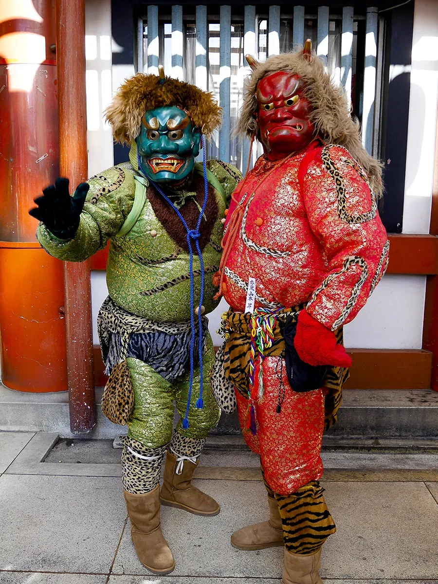 Red and green oni costumes worn during the Setsubun festival at Osu Kannon Temple.