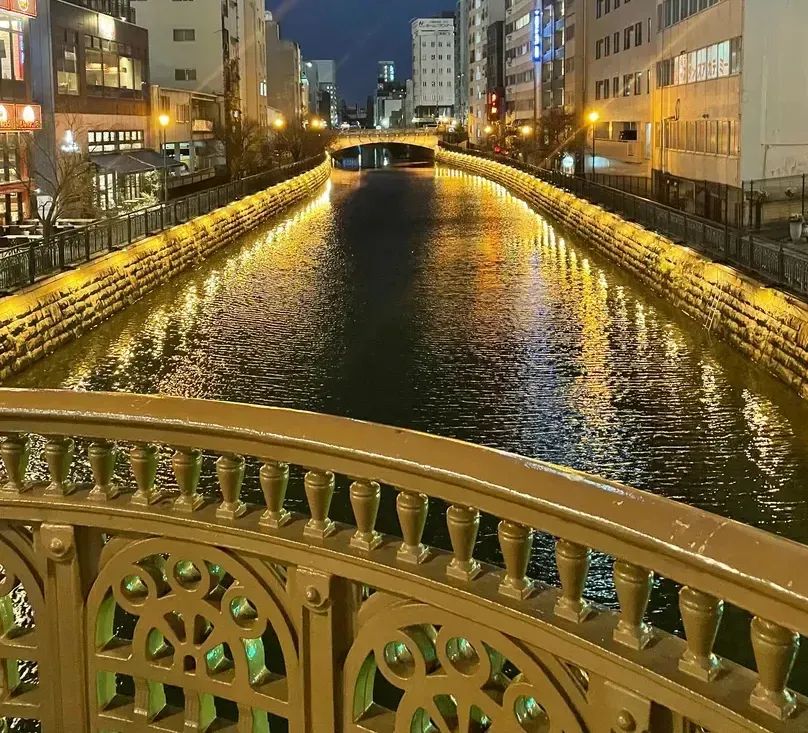 Nayabashi Bridge lit up at night over the Horikawa Canal