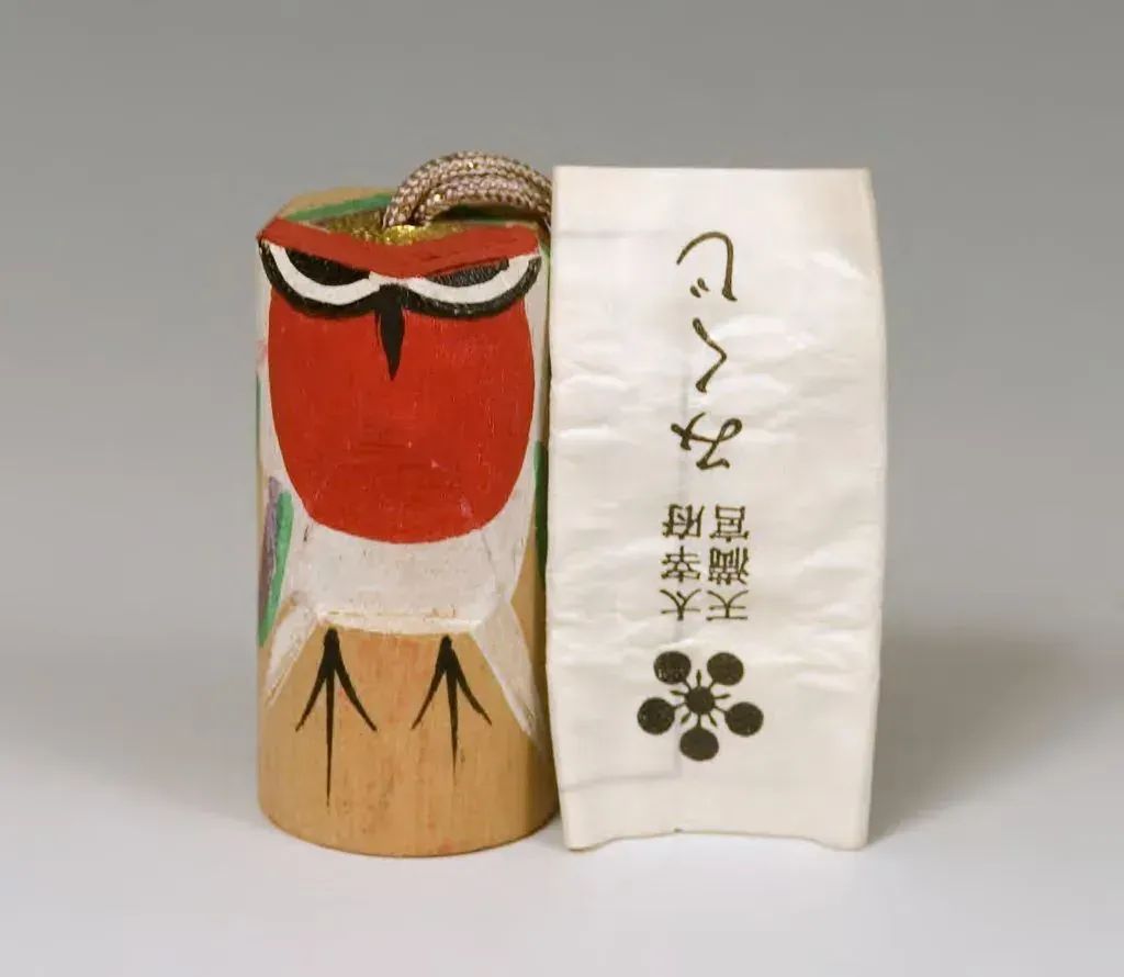 Wooden bullfinch charm for Usokae ritual at Yamada Tenmangu