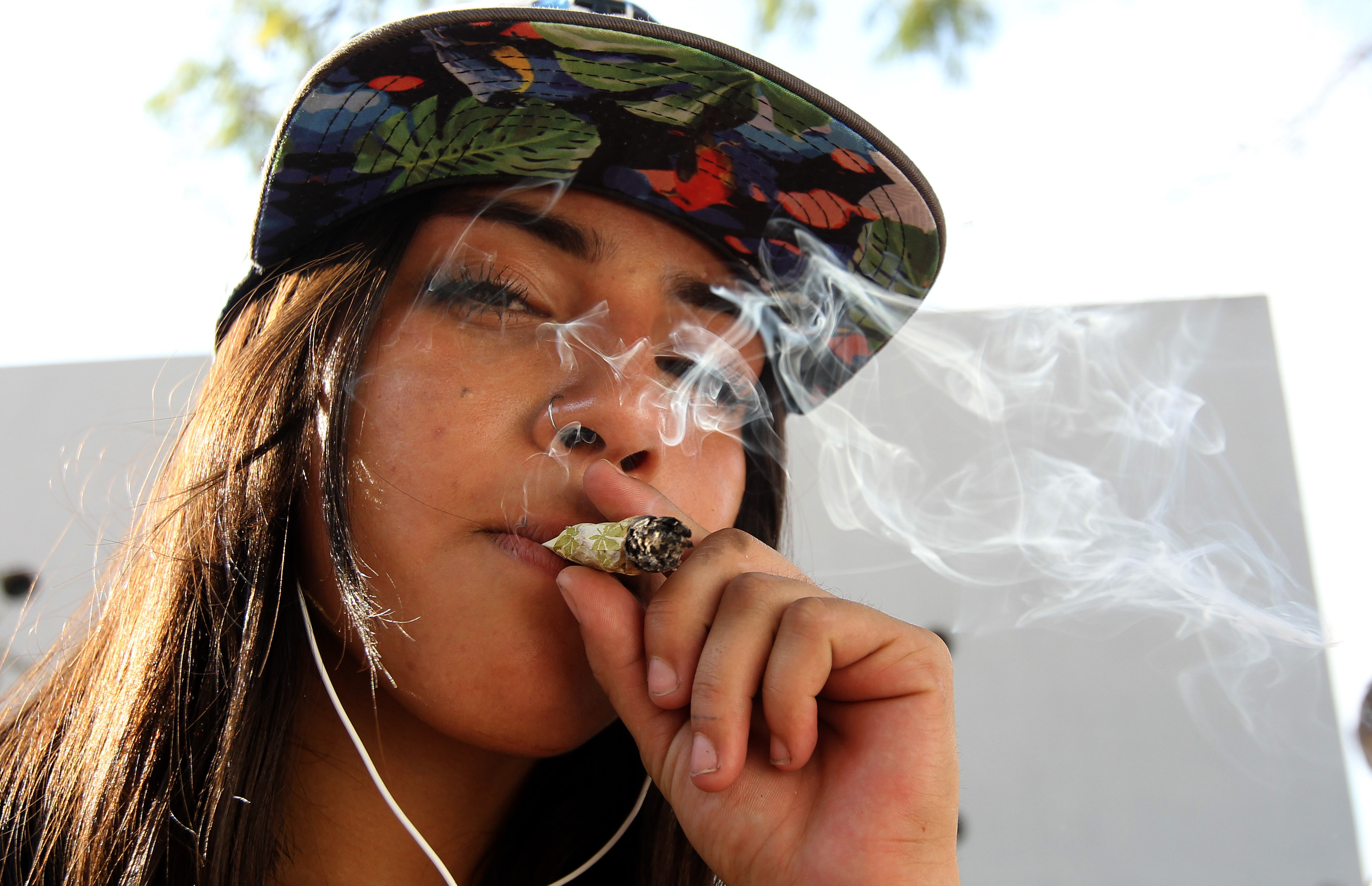 Youngster smokes a joint in favor of the legalization of Cannabis in Mexico photo.