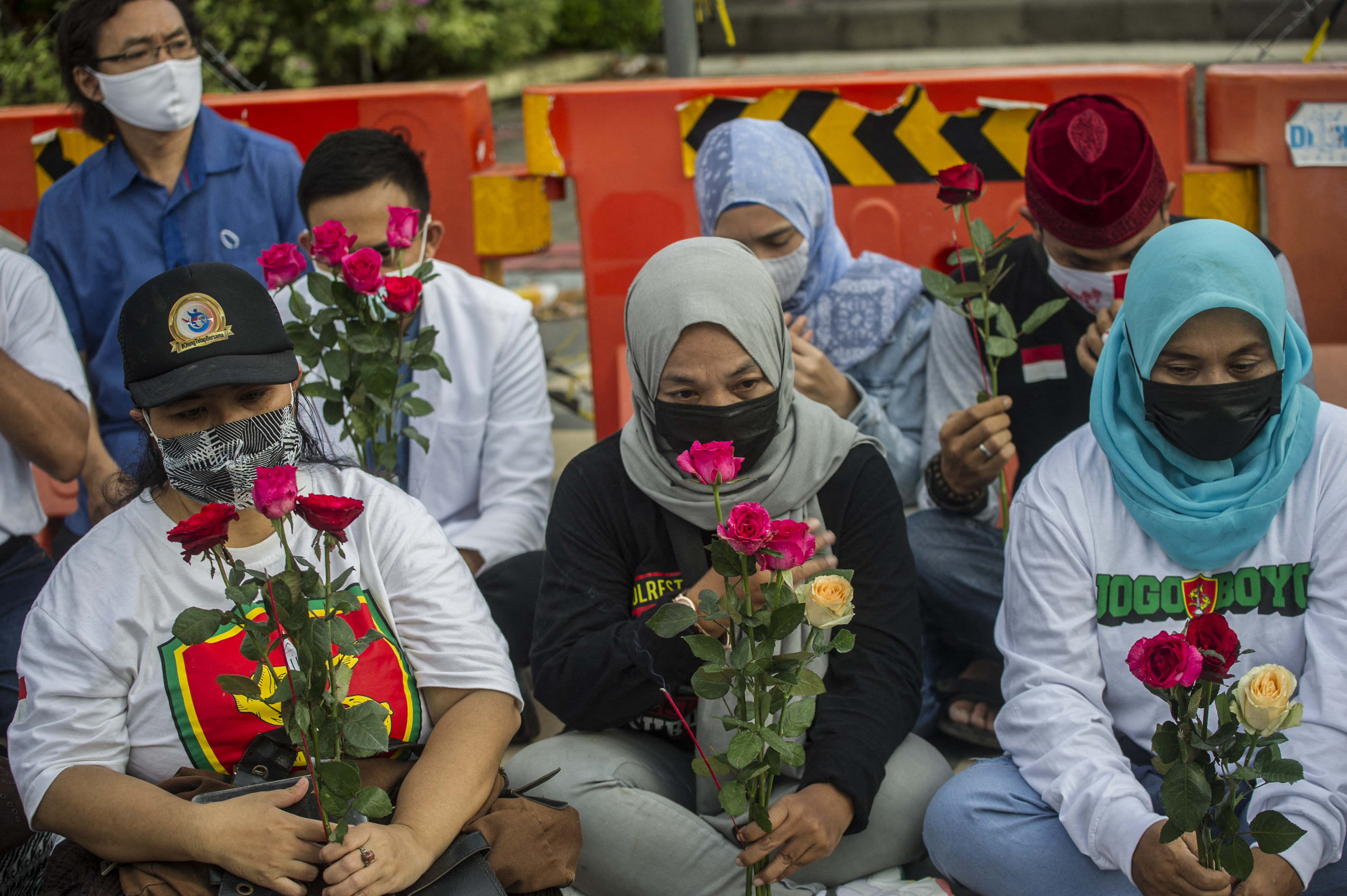 People gather to offer prayers for the 53 sailors trapped in the submarine in Surabaya on April 25, 2021, as Indonesia's military confirmed that all 53 crew were dead. 