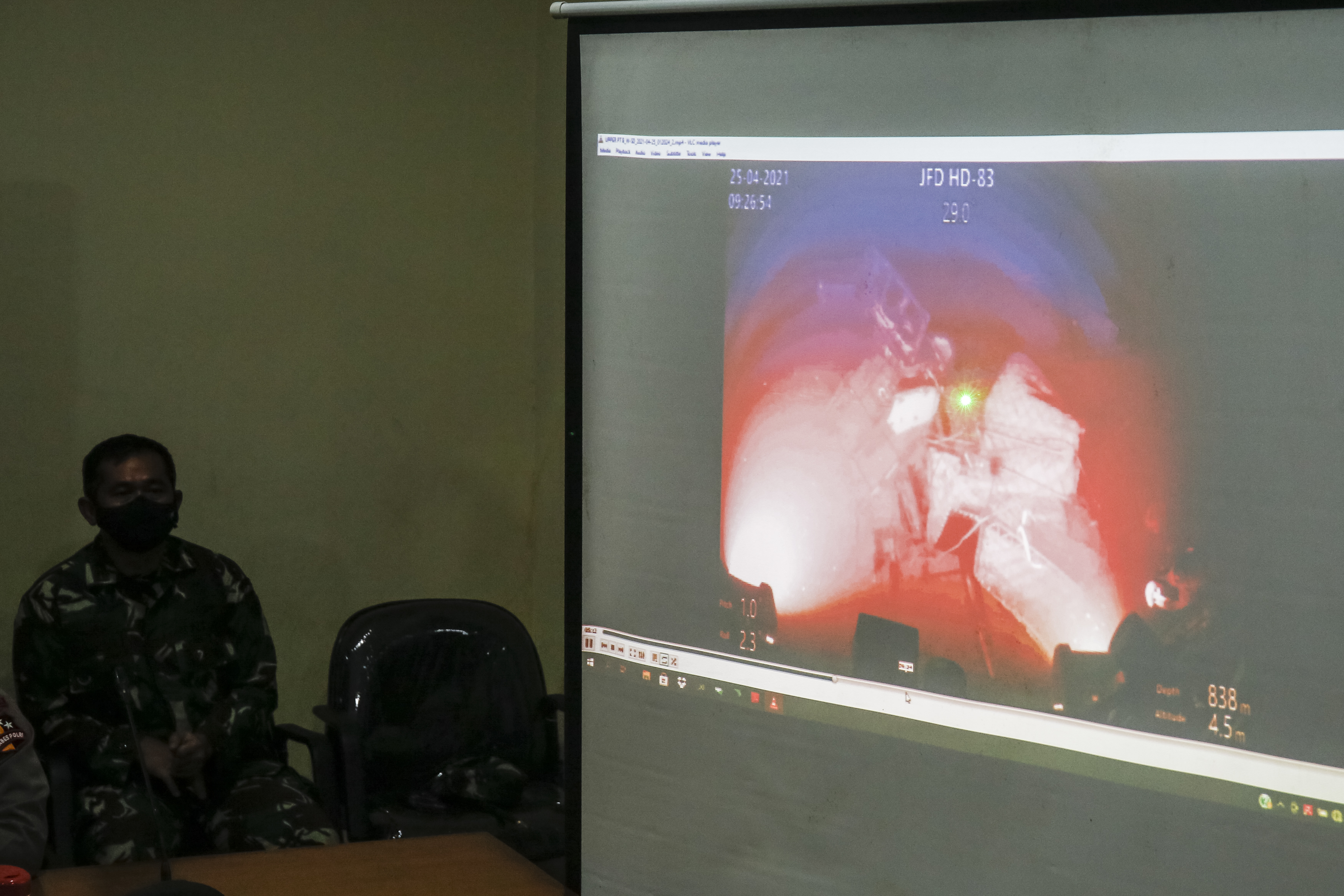 Indonesian military officer shows the video of body part of sunken Indonesian Navy submarine KRI Nanggala 402 taken from Remotly Opereted Vihacle (ROV) from MV Swift Rescue during press conference at Ngurah Rai Military Air Base in Kuta, Bali, Indonesia.