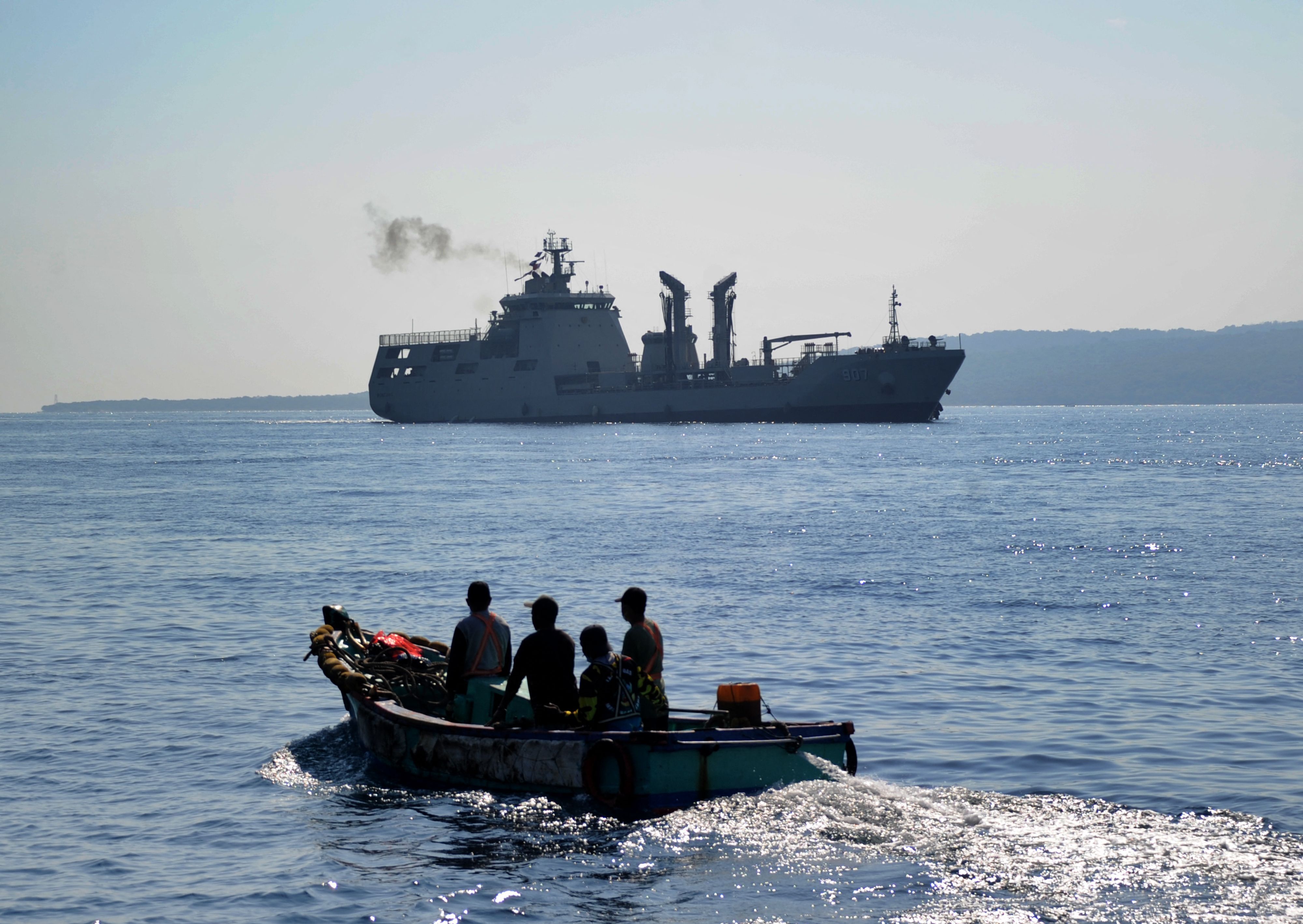 The Indonesian Navy patrol boat KRI Bontang (907) (back) arrives at a naval base in Banyuwangi, East Java province, after an Indonesian submarine that disappeared last week had been found in pieces on the seafloor with all 53 crew aboard killed.