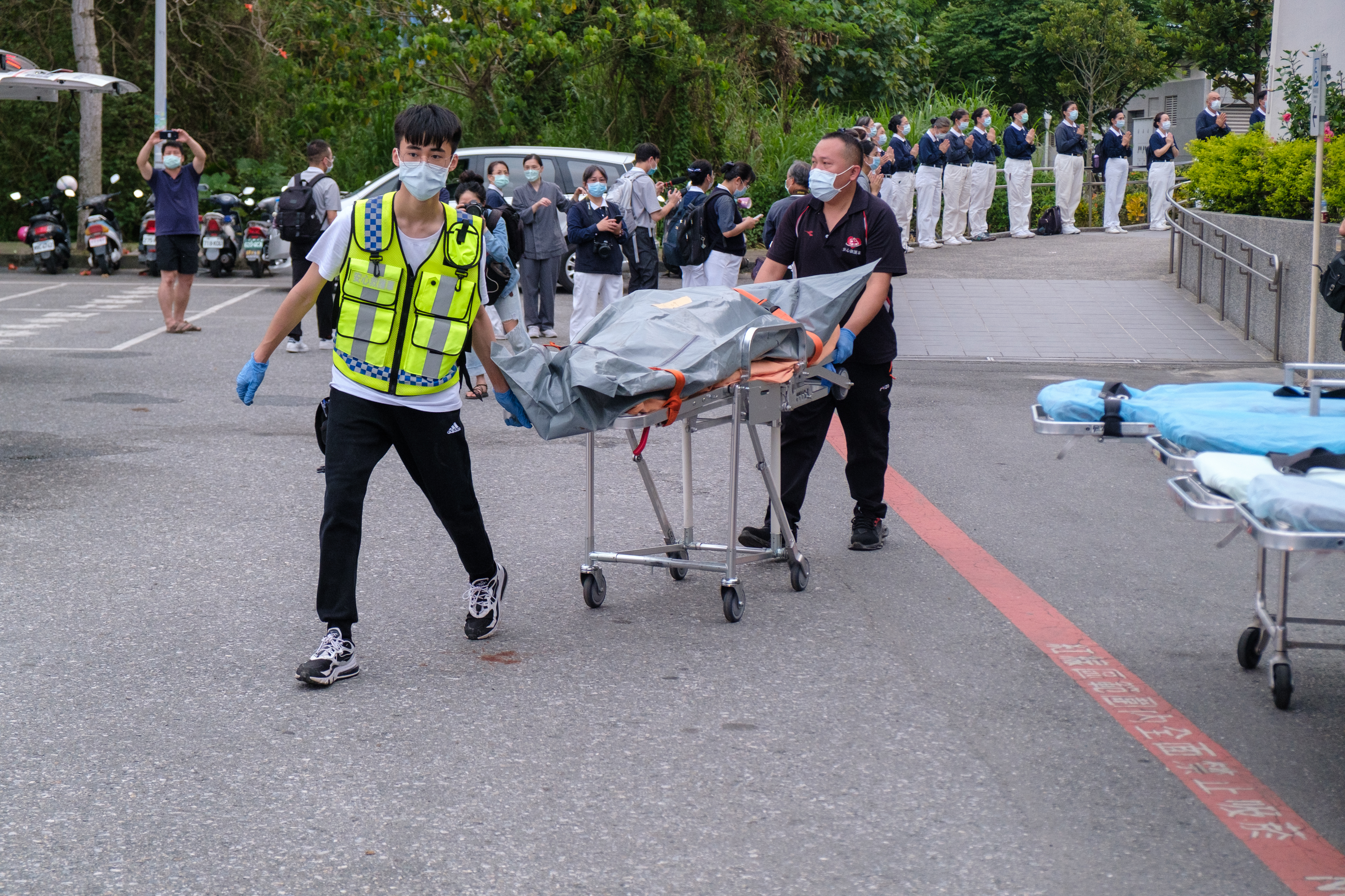 A group of first aids carrying a dead body pouch out of a special train after the train crash in Hualien photo.