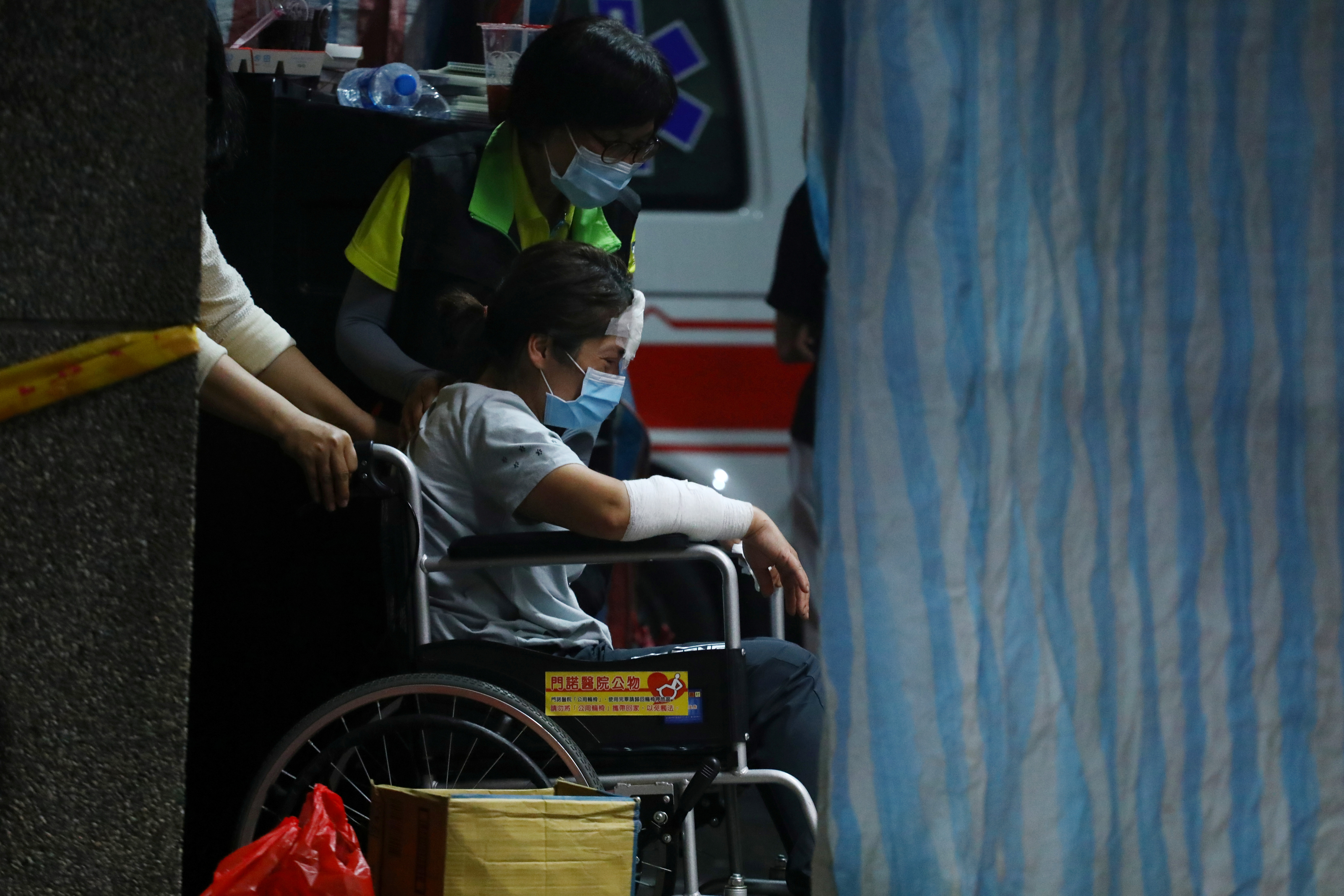 A wounded family member enters the morgue for body identification at a funeral parlour photo.