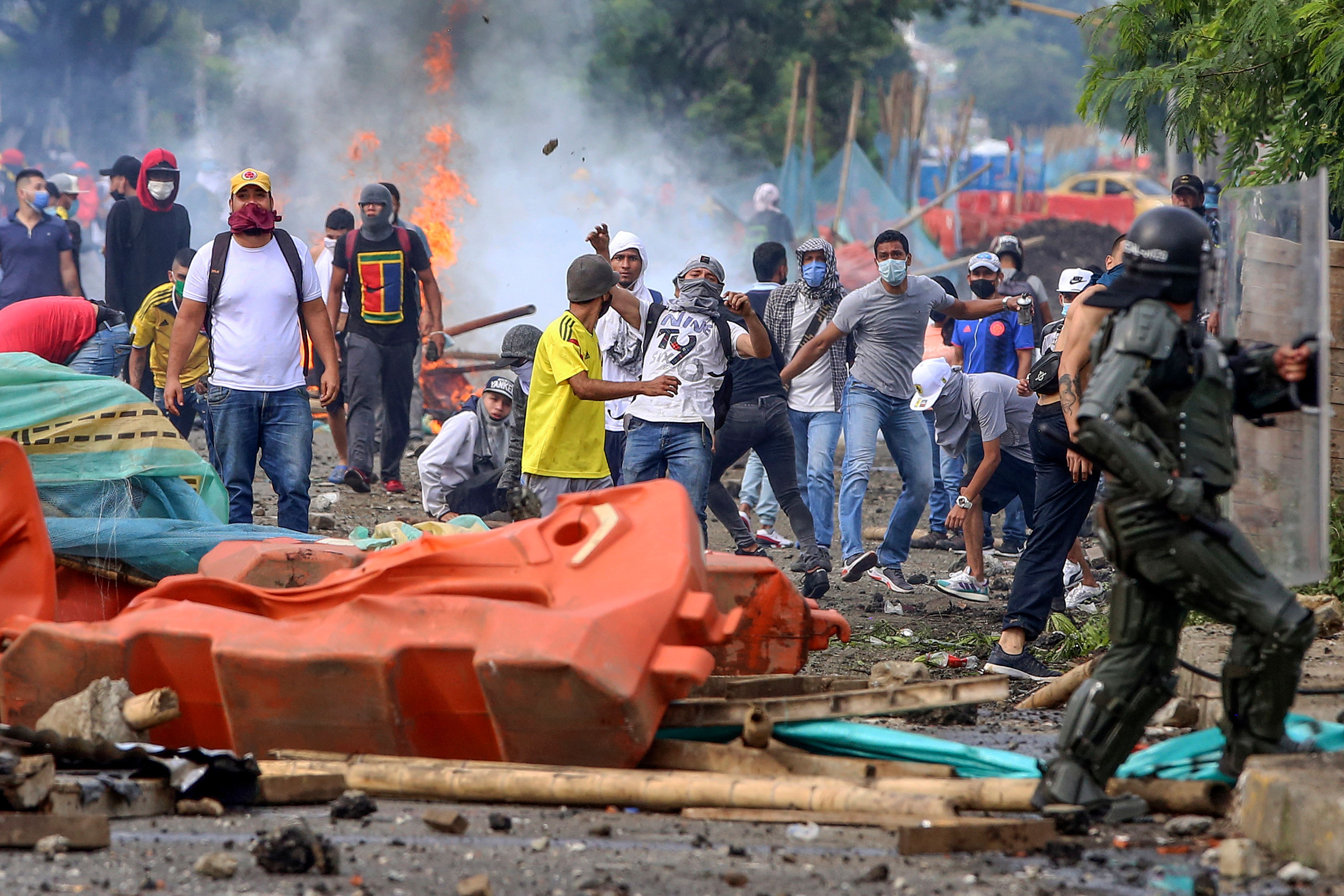 Demonstrators clash with riot police during a protest against a tax reform bill launched by Colombian President Ivan Duque, in Cali, Colombia.