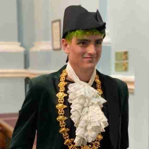 Owen Hurcum wears green costume.