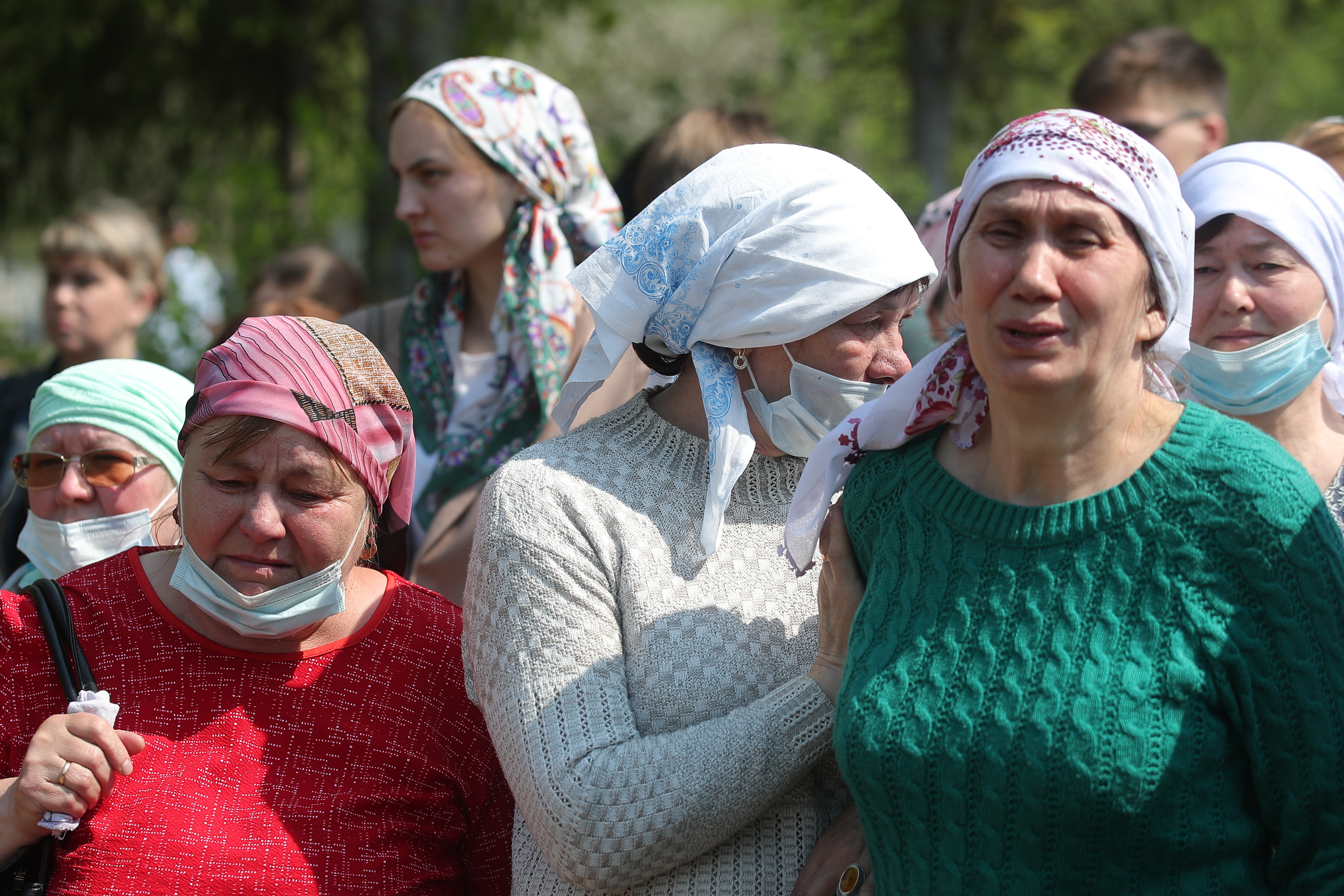 Relatives and friends grieve during the funeral of a school shooting victim, teacher Elvira Ignatyeva, at Samosyrovskoye Cemetery.