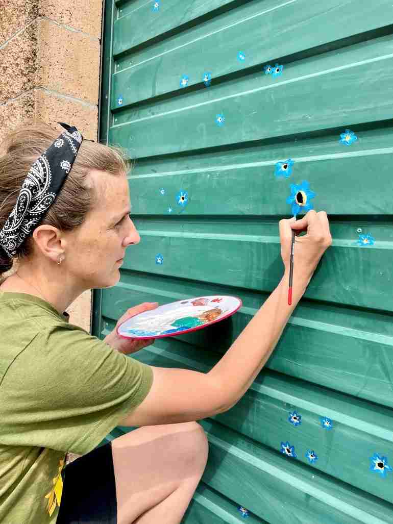 flowers over bullet holes bucha ukraine ivanka siolkowsky