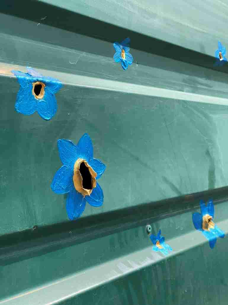 flowers over bullet holes bucha ukraine ivanka siolkowsky