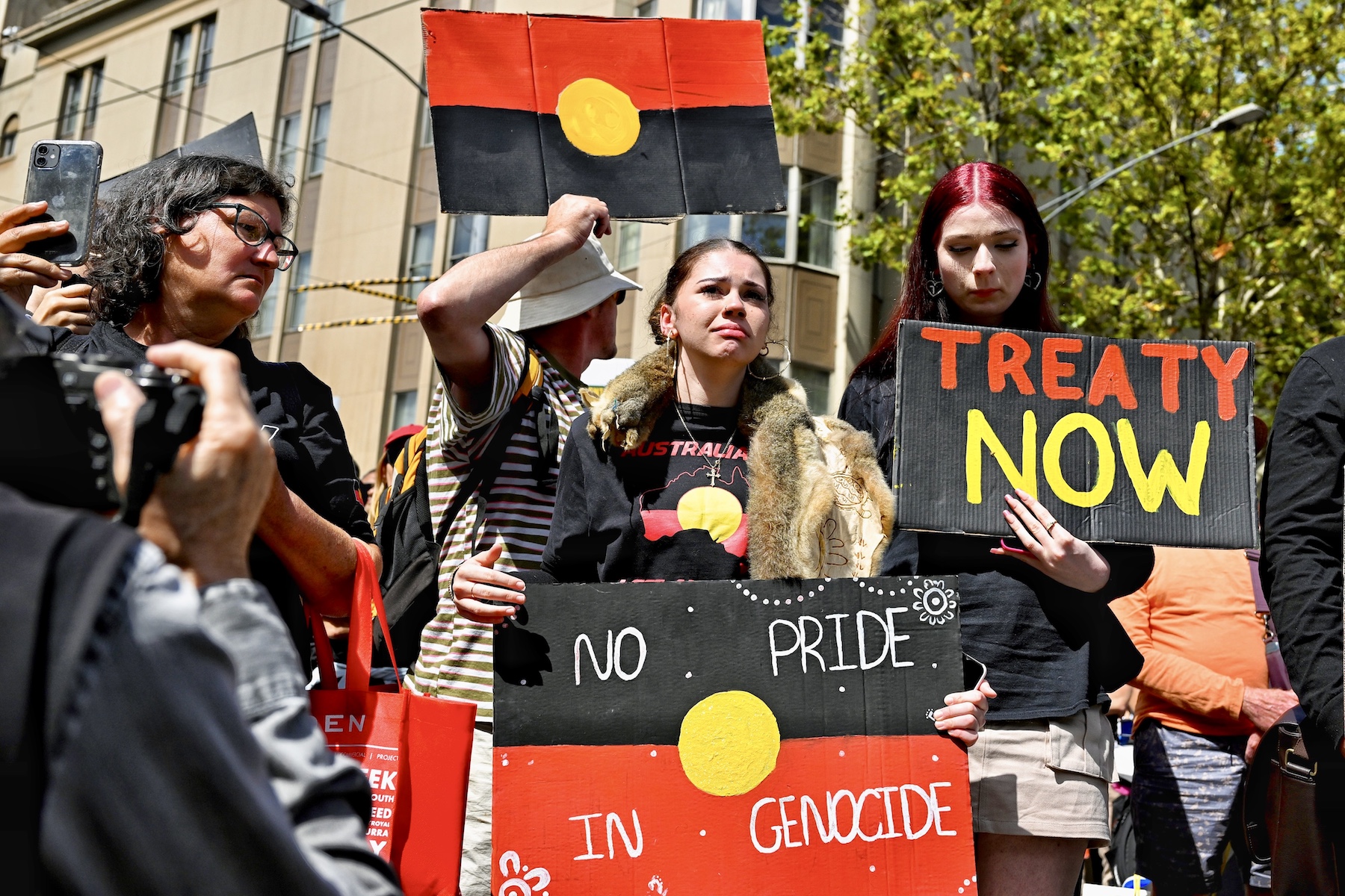 girl with justice sign australia invasion day protest 2023