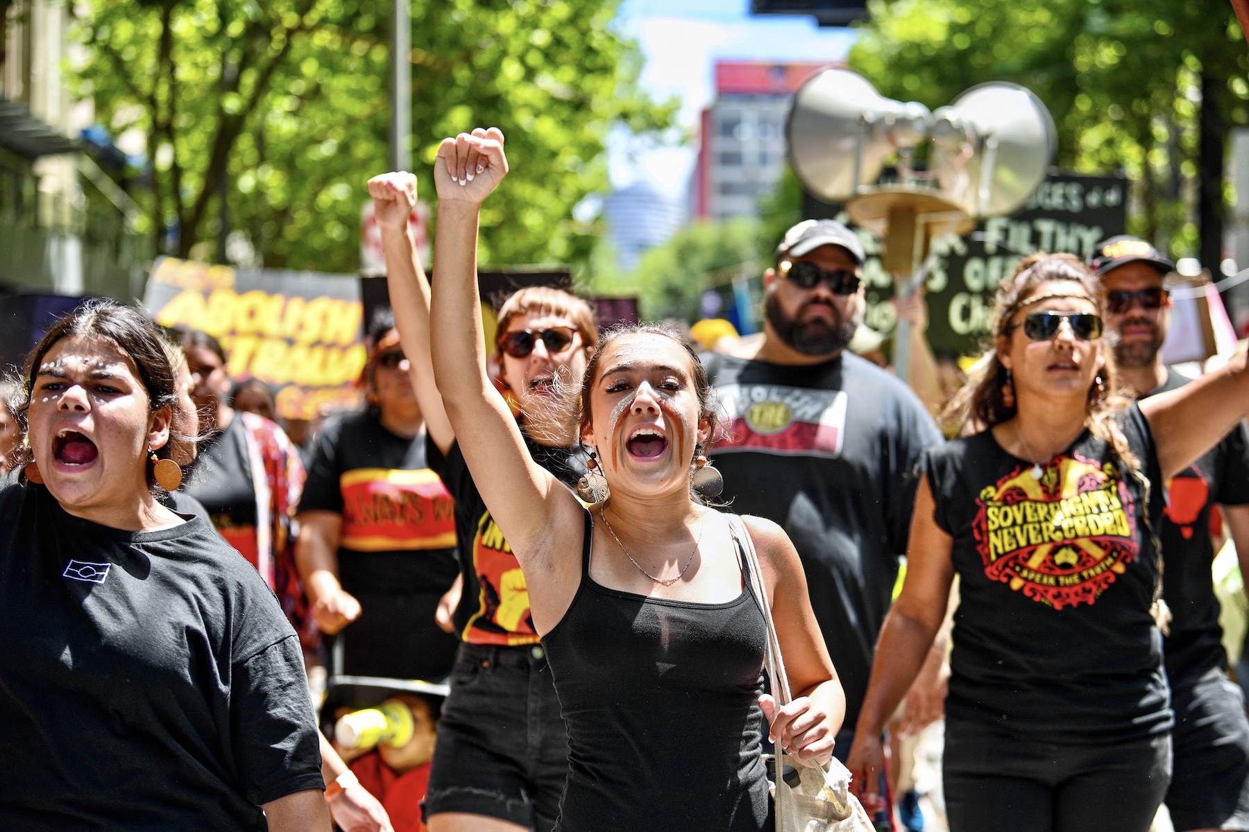 girl with justice sign australia invasion day protest 2023