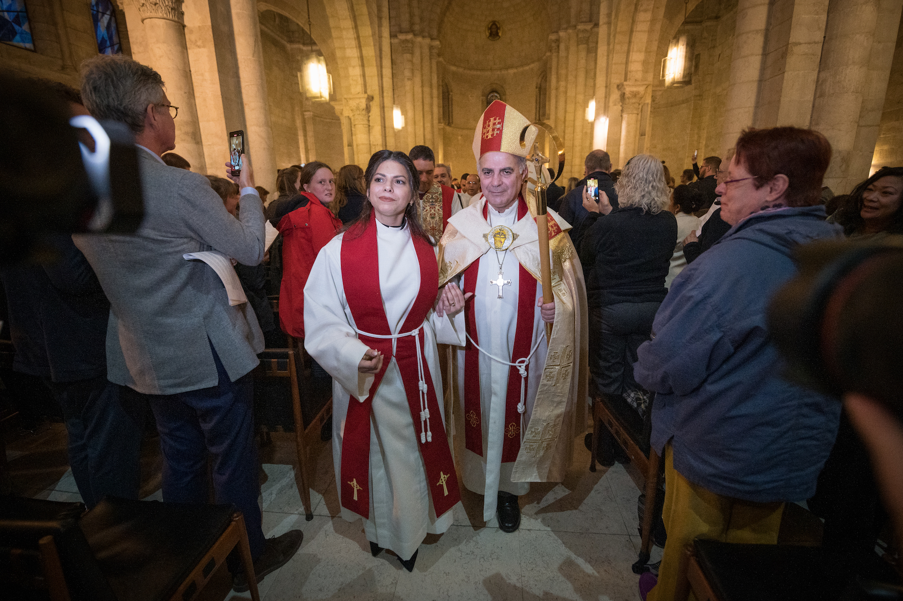 pastor sally azar walking down the hallway in the church with her father