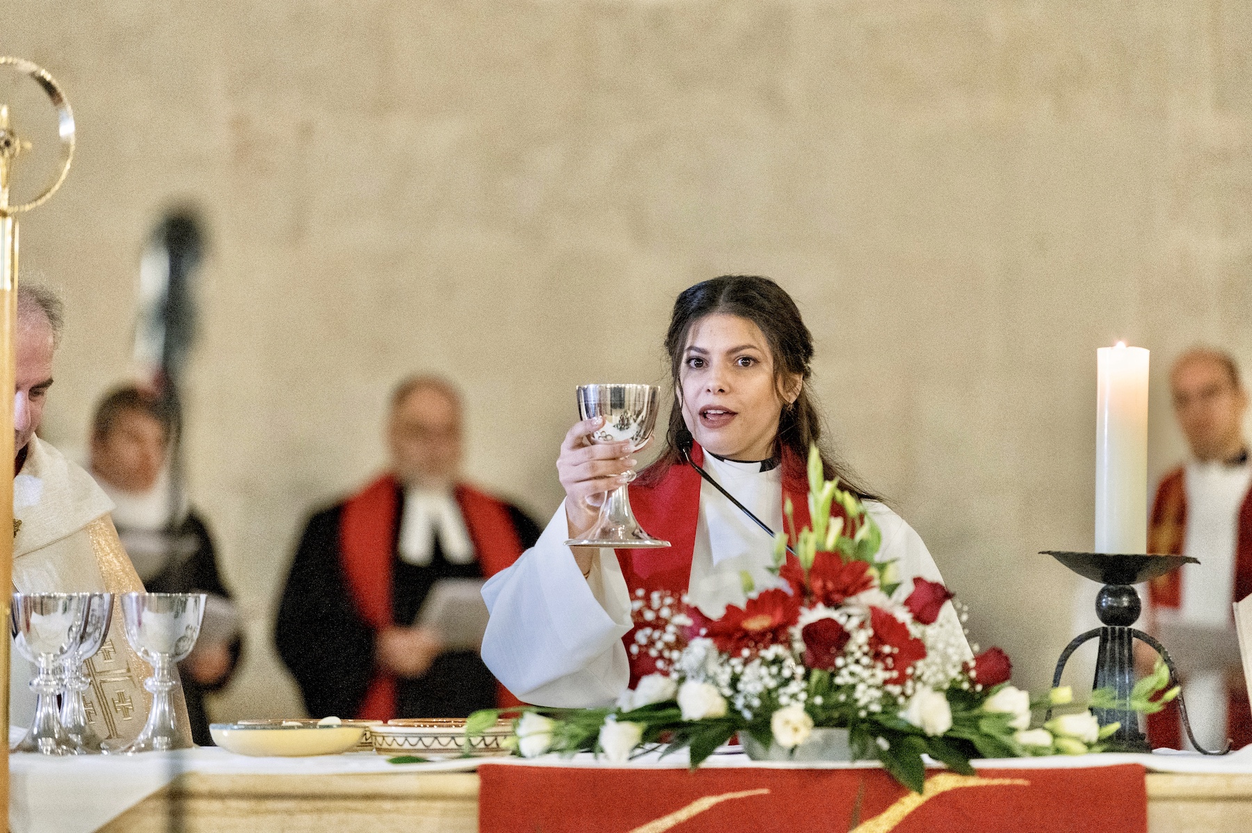 pastor sally azar being ordained and sharing messages holding a holy cup