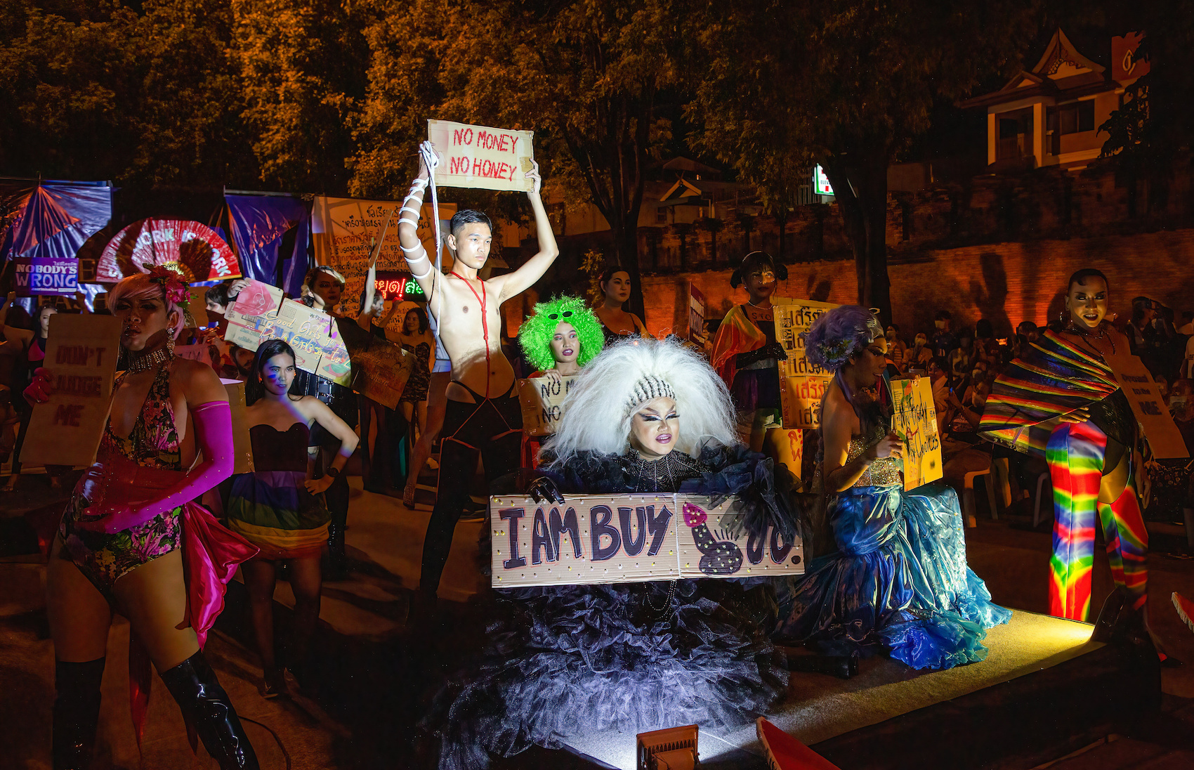 Thai activist on the catwalk holds a placard during a Sex Work Fashion Week on International Labor Day at the Tha Phae Gate