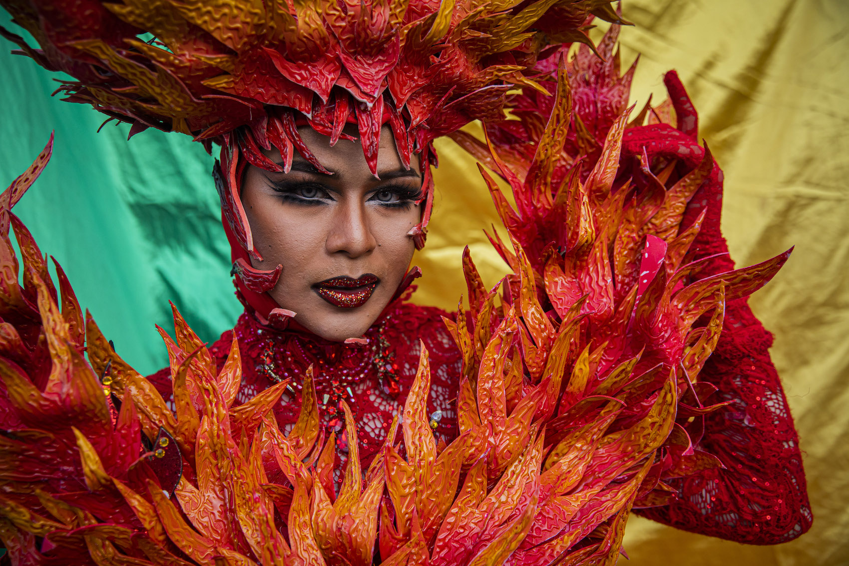 Members of Sixcret Show, a cabaret troupe, post for photos with a rainbow flag after their performance at the Sex Worker Fashion Show on May 01, 2022 in Chiang Mai, Thailand