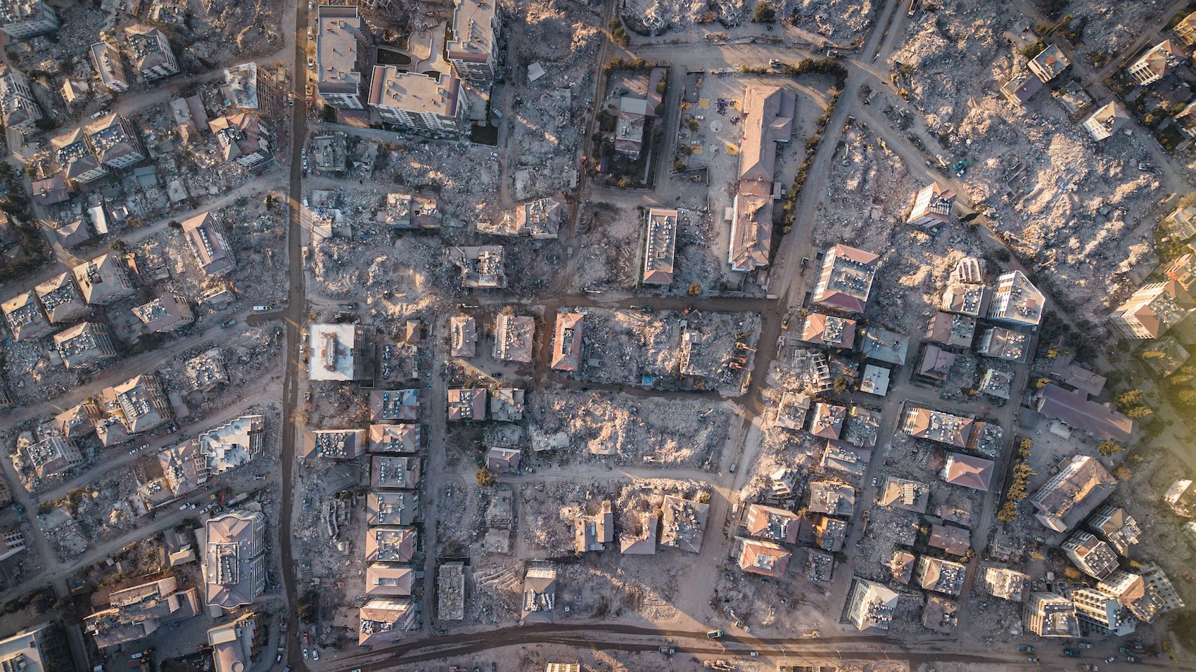 An aerial photograph shows collapsed buildings in Antakya