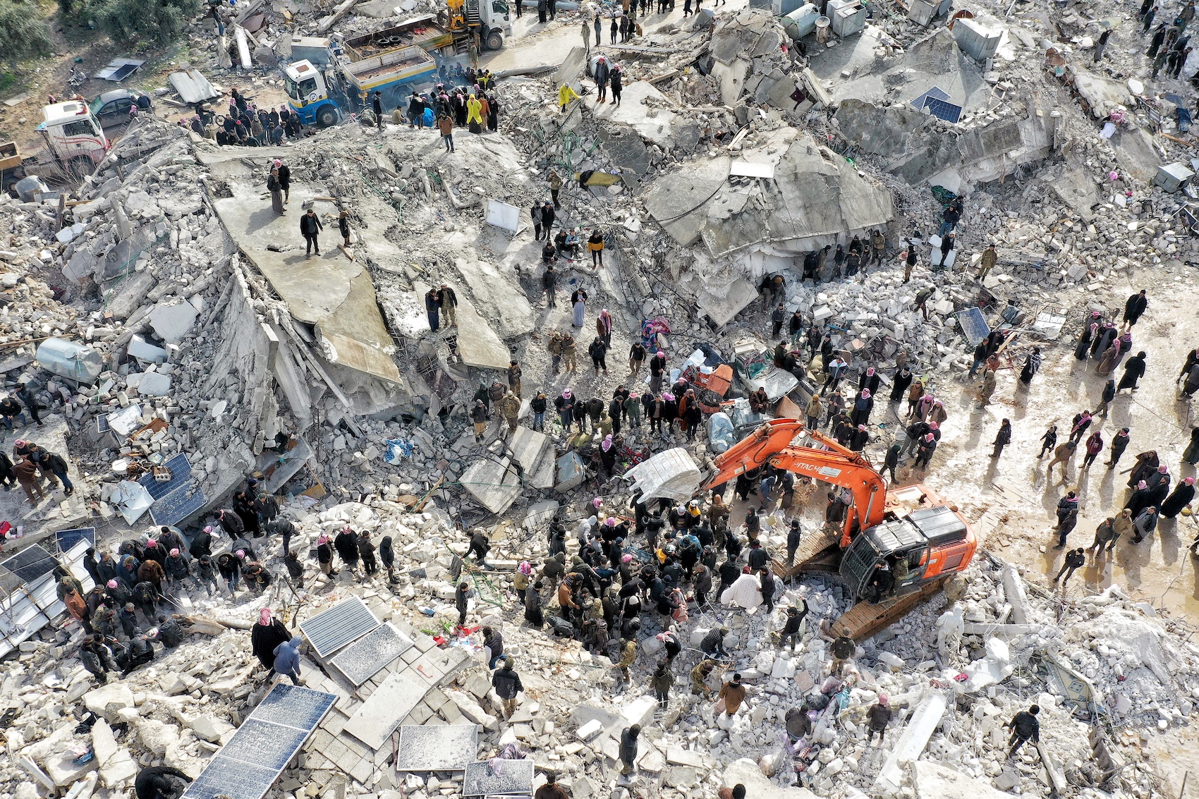 a picture of the destroyed site where people gathering for help
