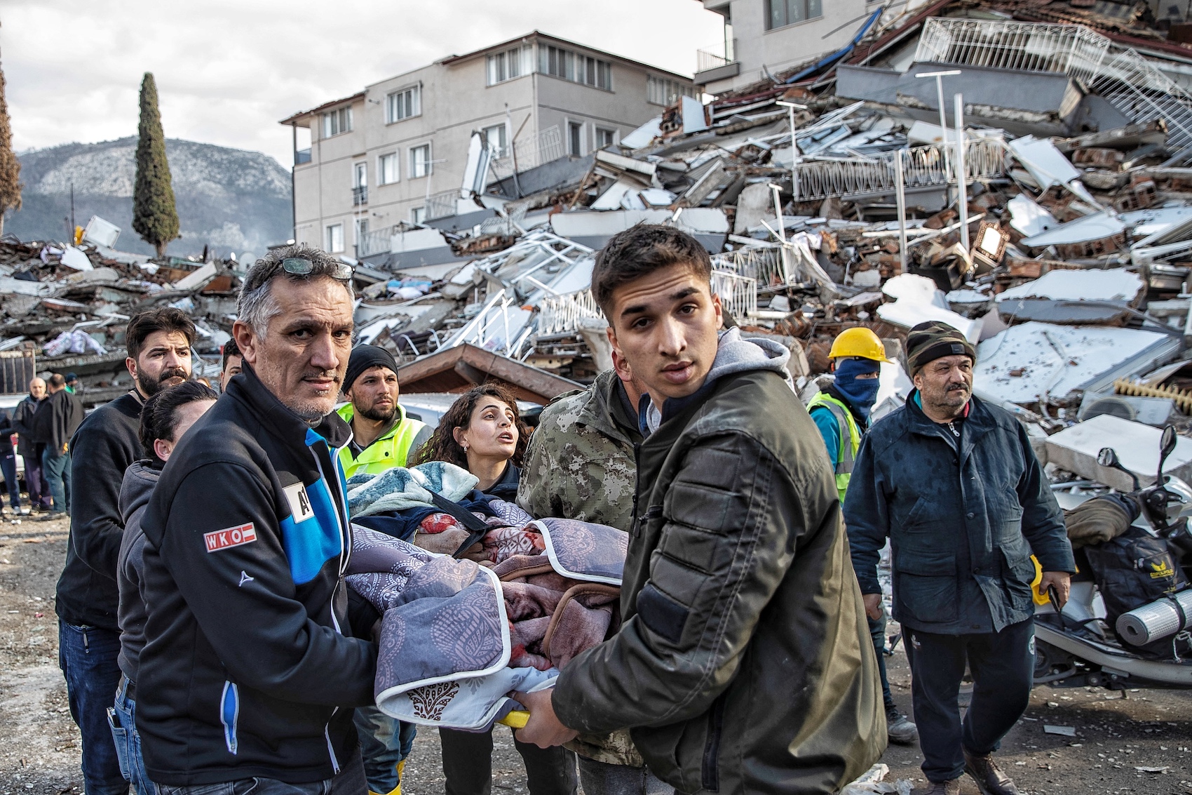 rescuers are carrying the wounded people out from the wrecks