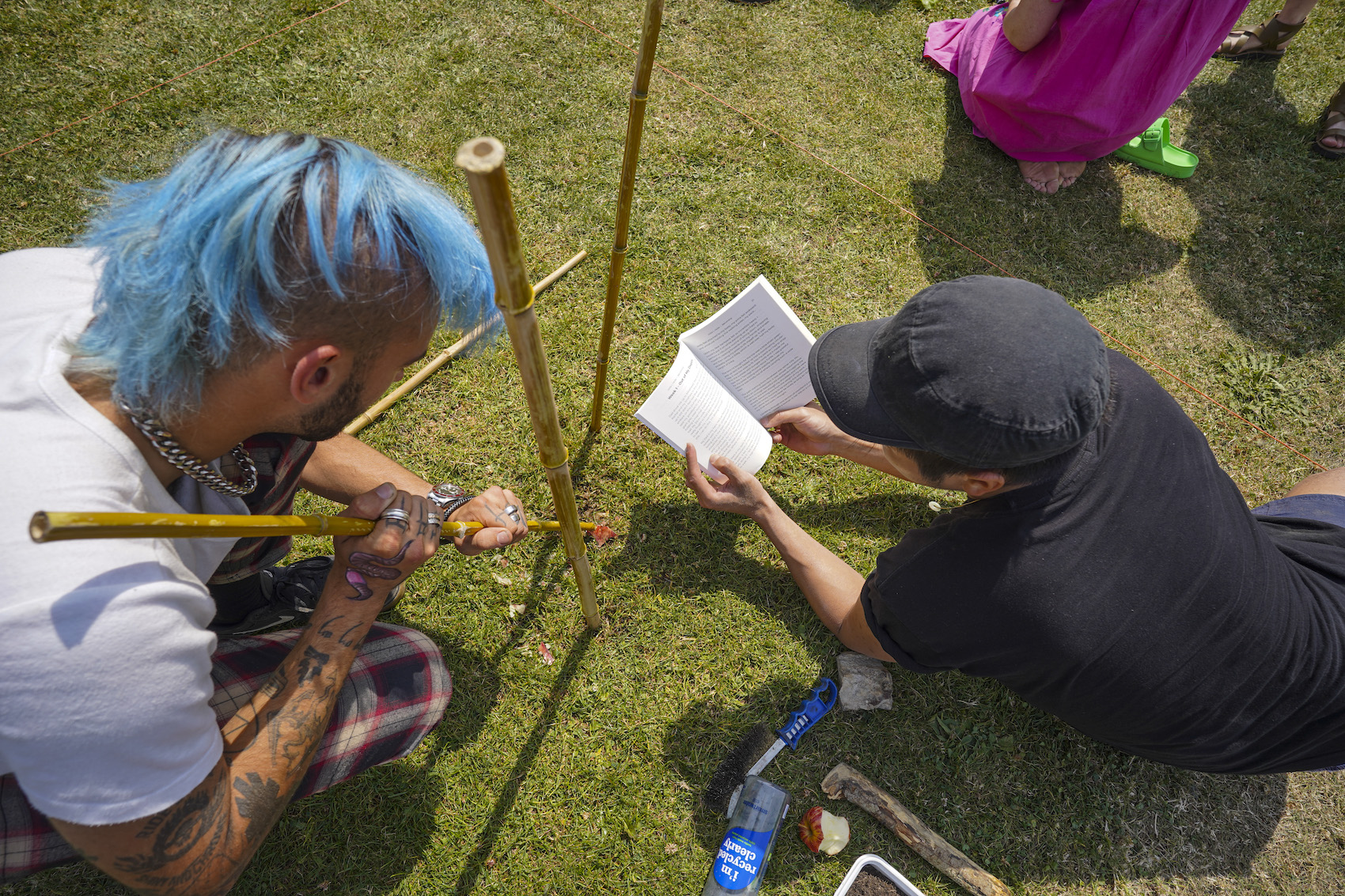 2 competitors as a group studying how to get the worms out of the soil