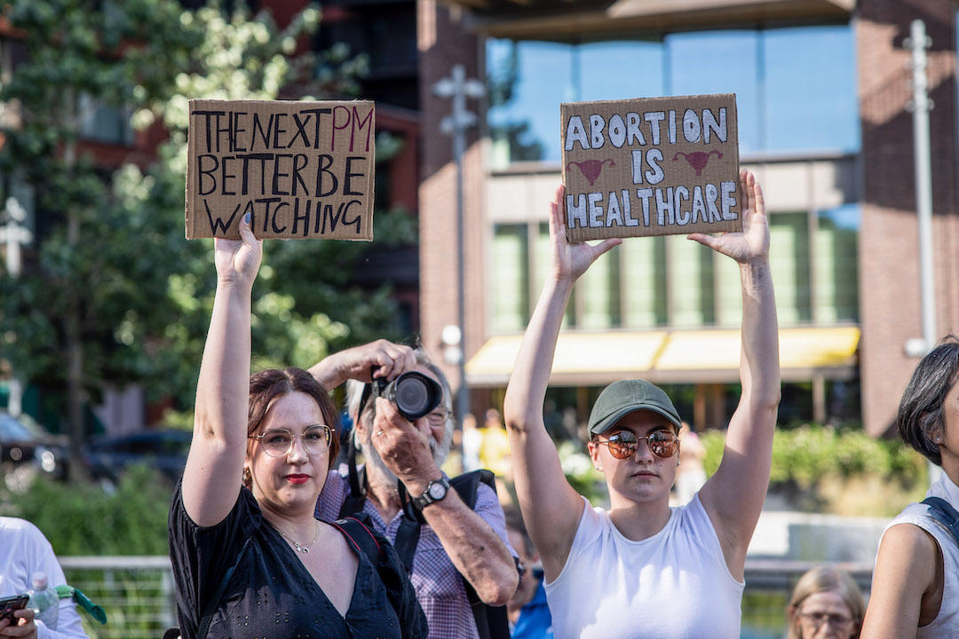 British women hold up pro-abortion signs