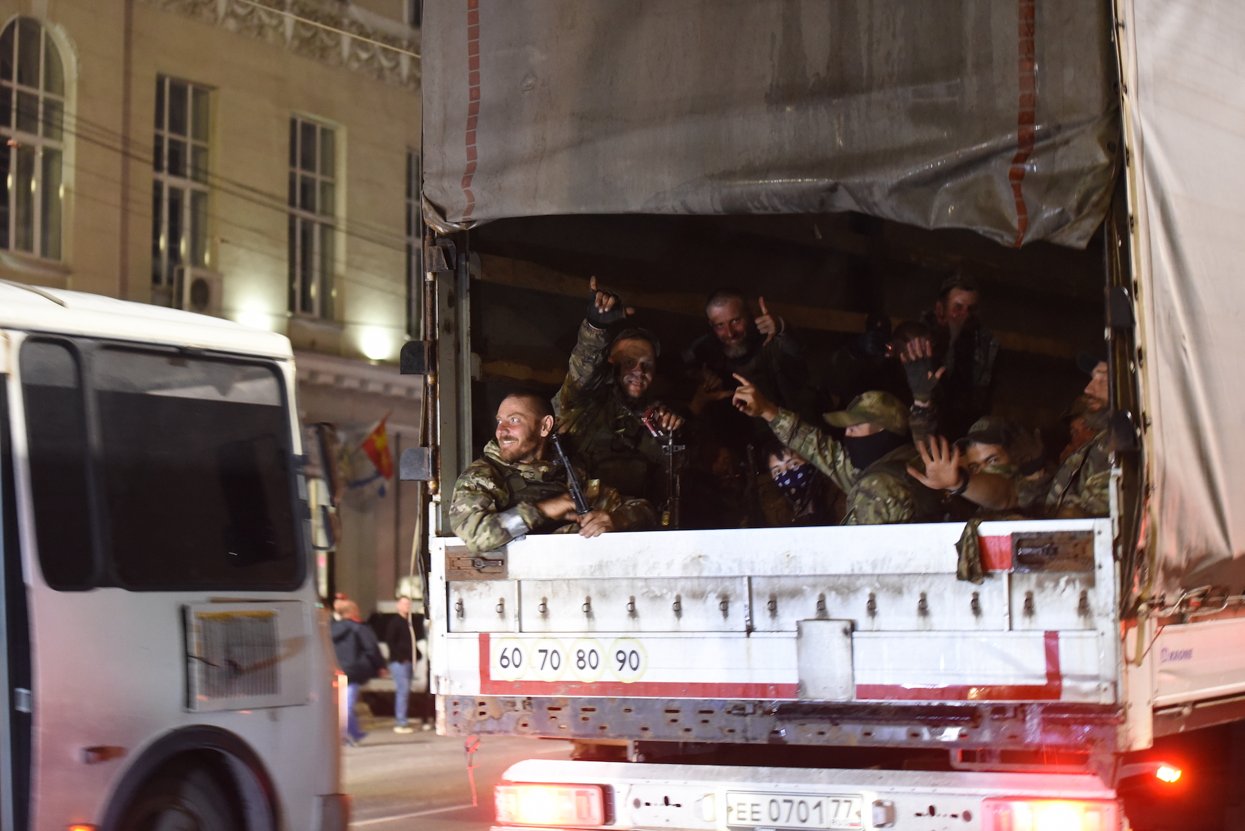 Members of Russia's Wagner group ride on a truck