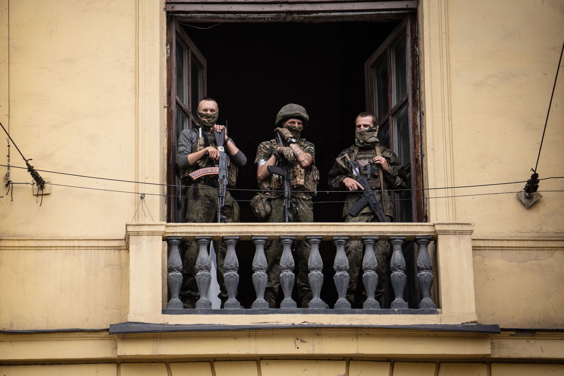 Three soldiers from Wagner group stand on the balcony