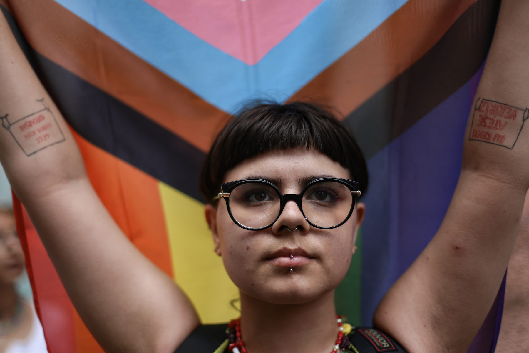 Activist holds LGBTQ flag during pride march in Istanbul, Turkey.