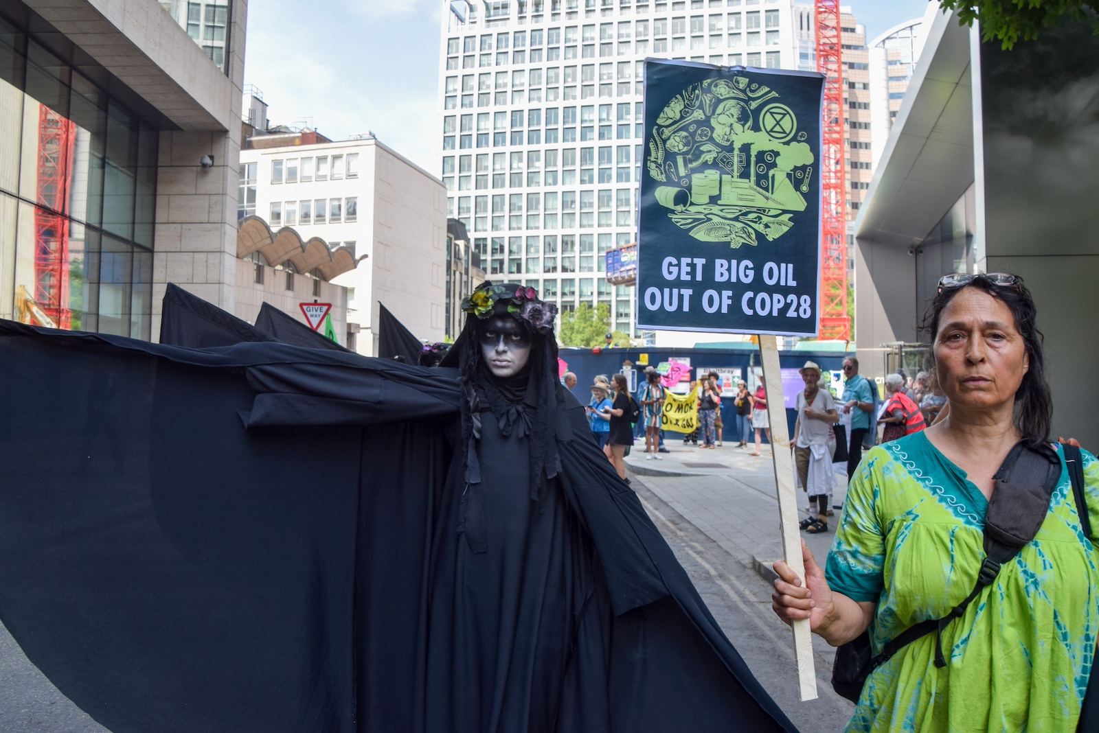 Oil Slickers perform during the protest cop28