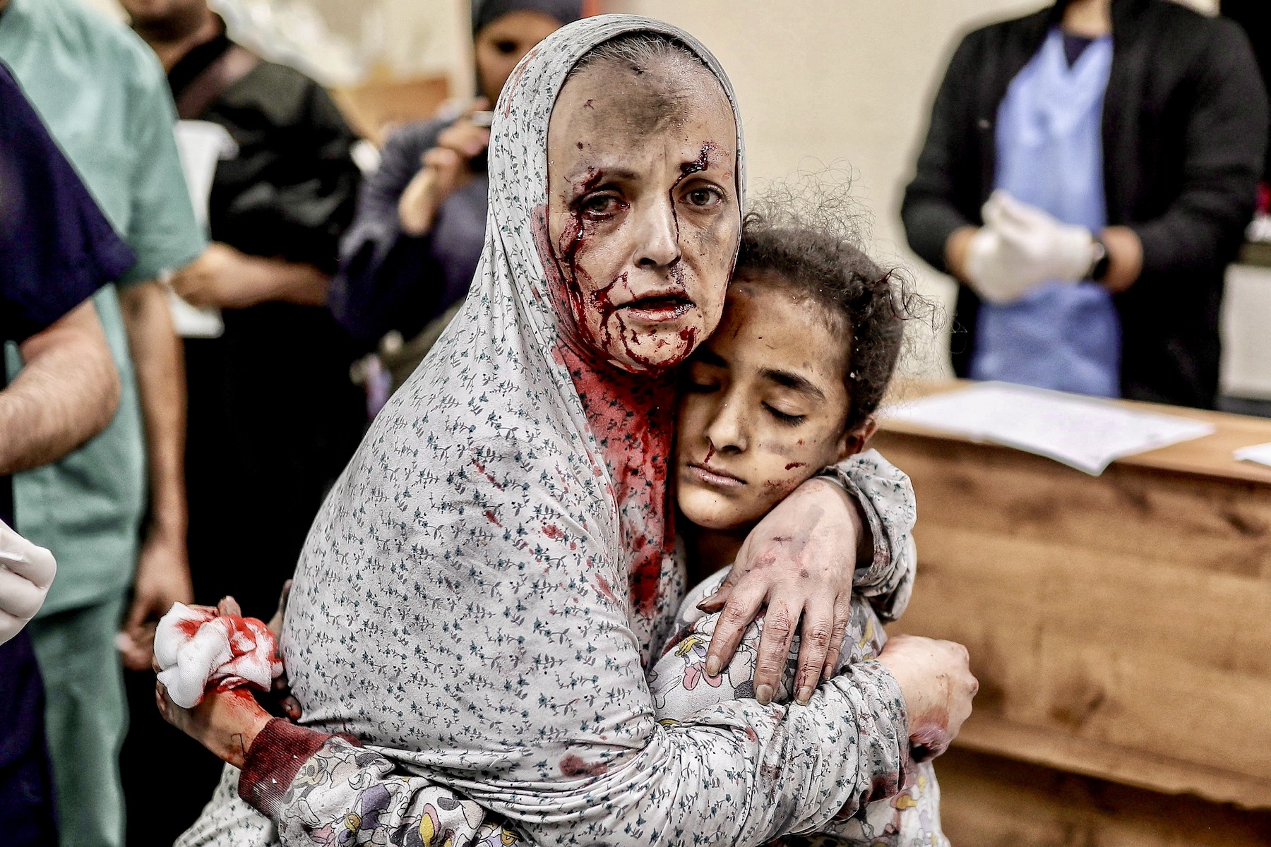 Palestinian woman covered in dust and blood gaza