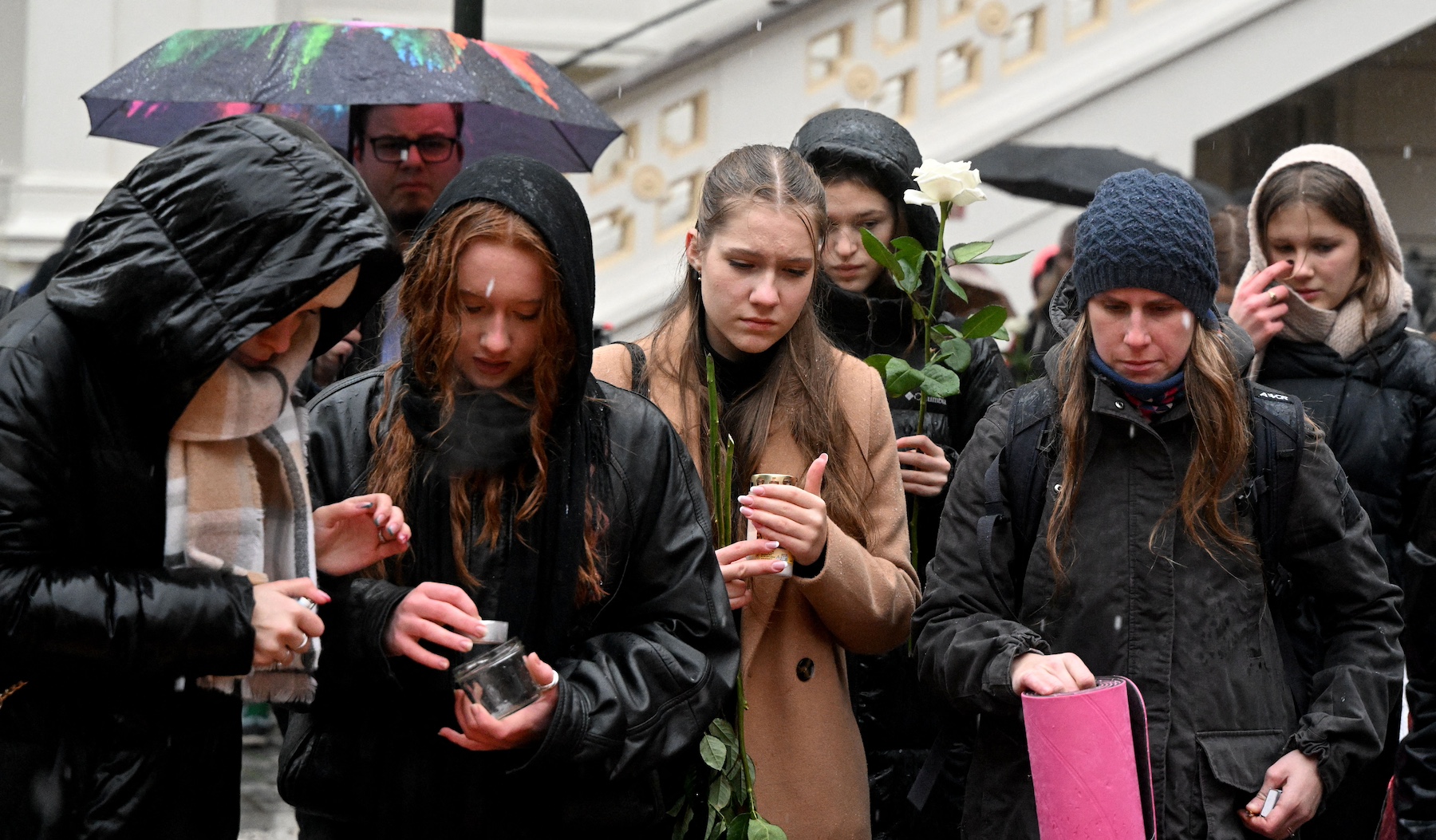 people light candles prague shooting
