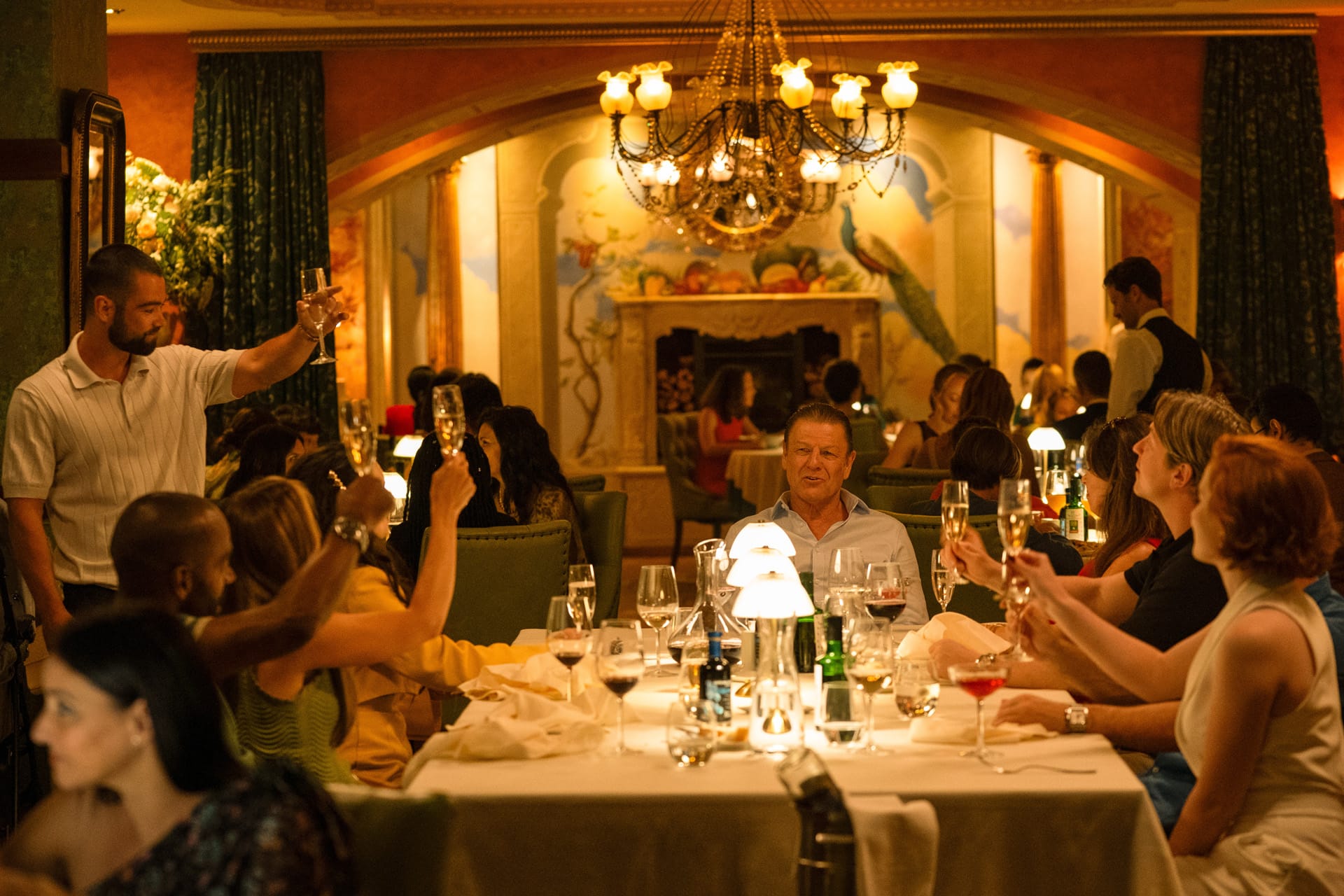 A family celebration. Jamie Phelan (Jack McMullen) toasts his father Ronnie Phelan (Sean Bean)