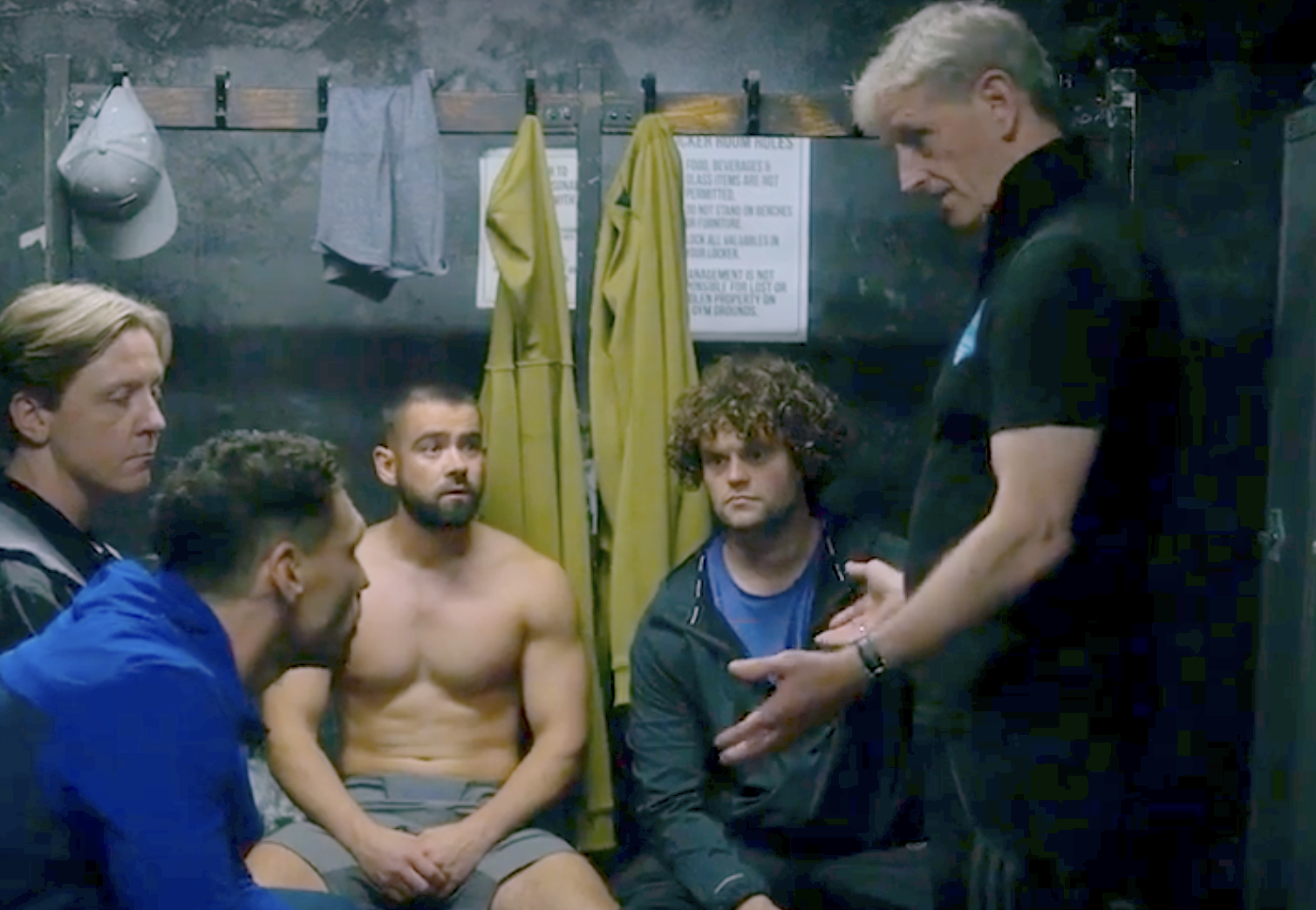 In the locker room, Terry (Andrew Schofield) explains the rules of the game to protagonists Michael (James Nelson-Joyce) and Jamie (Jack McMullen), attended by Banksey (Mike Noble) and Bonehead (Bobby Schofield). 