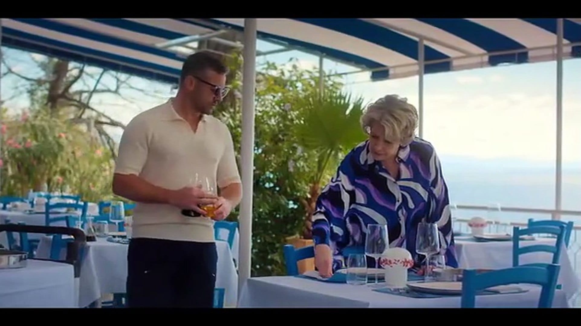 Joe (Warren Brown) and Elena (Phyllis Logan) set tables in the restaurant