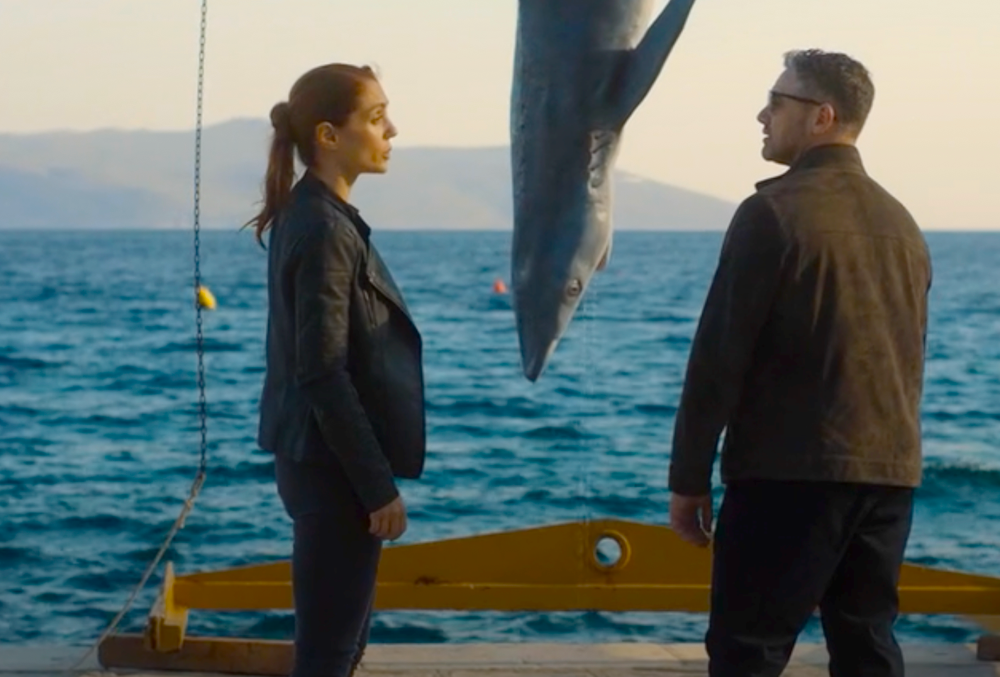 Lara Sarrancino (Cristiana Dell’Anna), Joe Mottram (Warren Brown) at the water's edge where the shark is hung.
