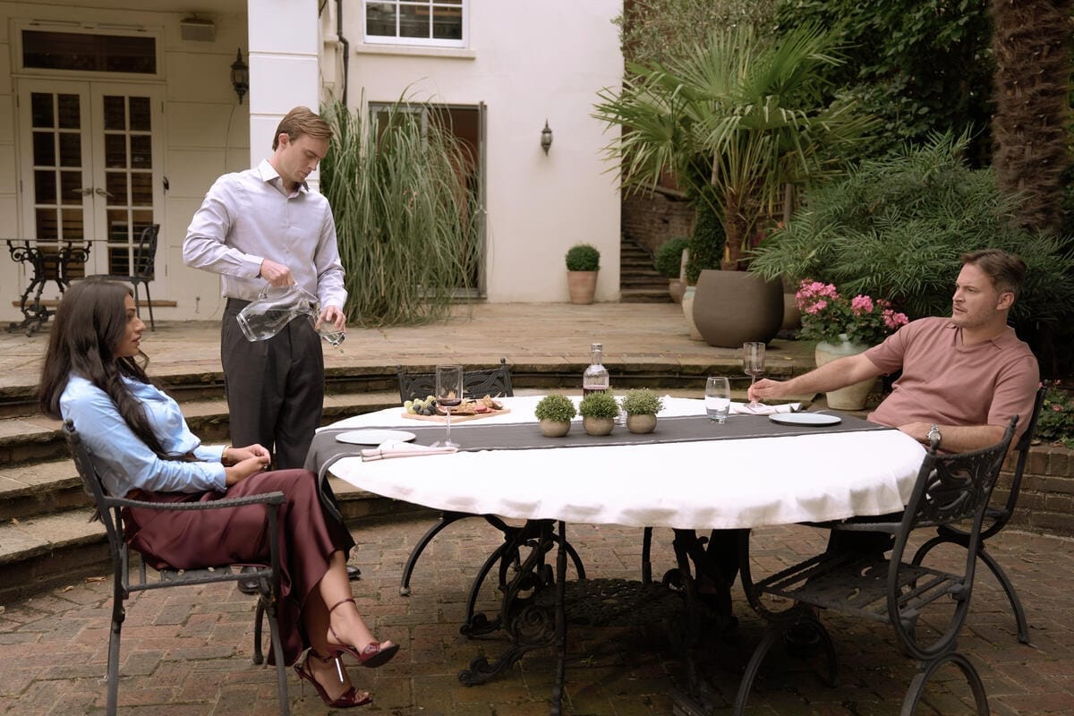 Claire (Saira Jackson) and husband Mike (Gary Lucy) dine in their garden served by handsome house manager Philip Hawksley (Jack Station)