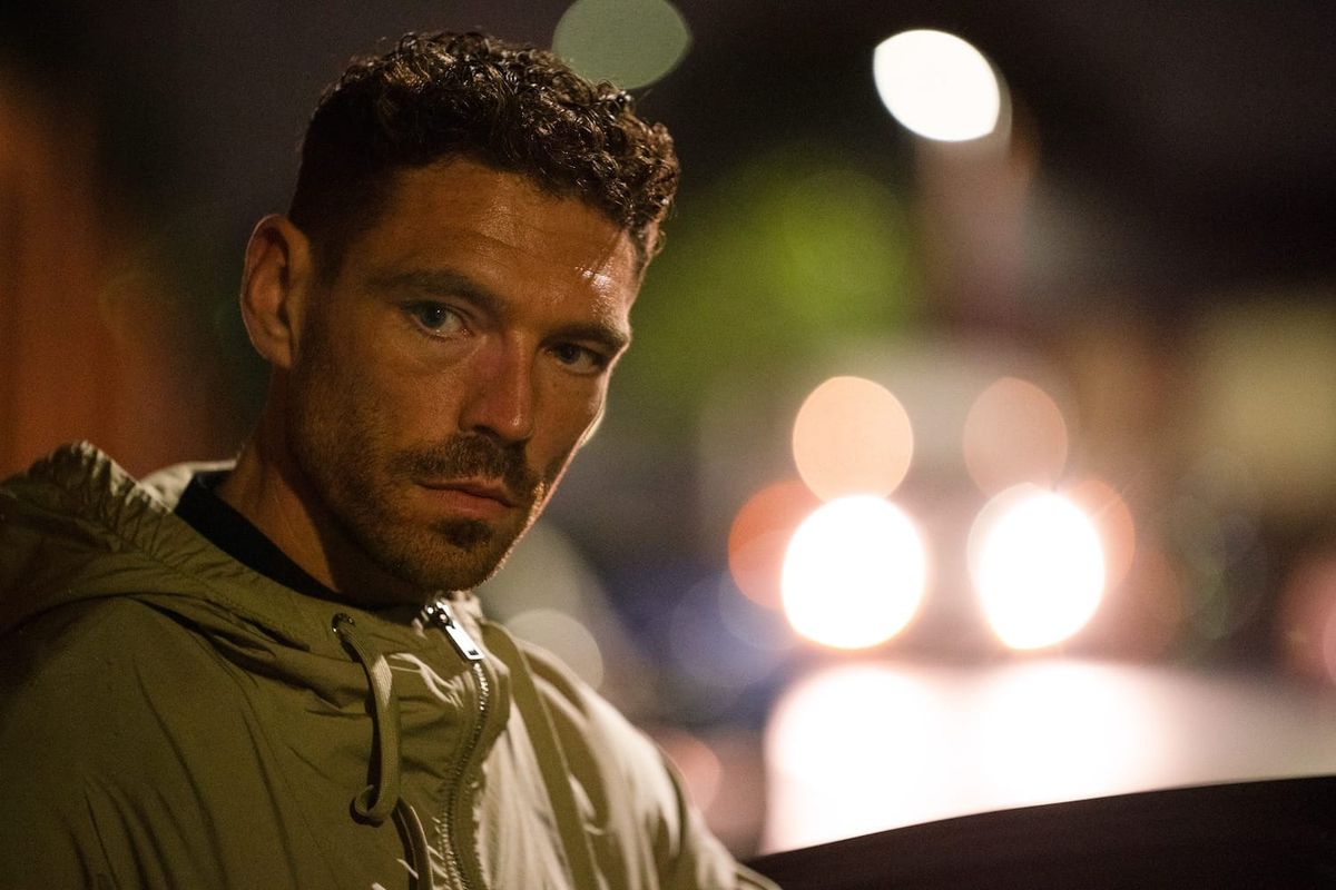 Michael Kavanagh (James Nelson-Joyce) in the city at night.