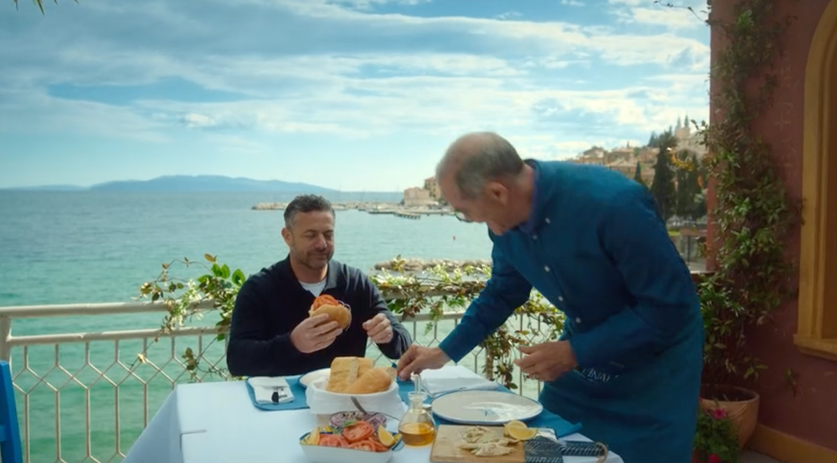 Joe and Gennaro assemble their freshly-caught and cooked fish sandwiches on a balcony overlooking the sea.
