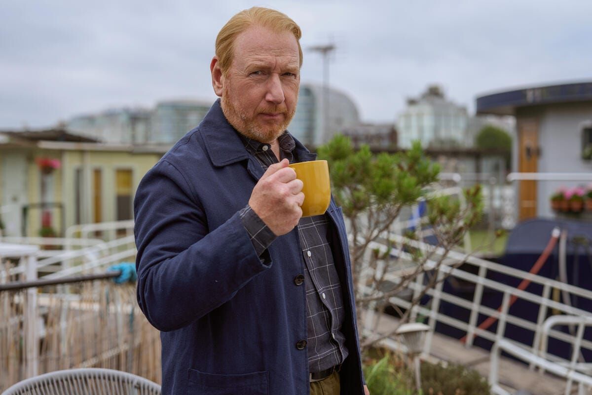 DI Max Arnold (Adrian Scarborough) aboard his houseboat enjoys a cup of coffee