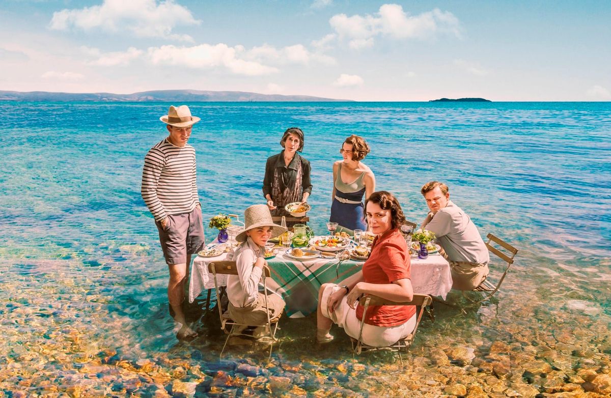 Louisa (Keeley Hawes) with her brood on the beach – Larry (Josh O’Connor), Leslie (Callum Woodhouse), Margo (Daisy Waterstone, Gerry (Milo Parker), and Landlady Vasilia (Errika Bigio) 