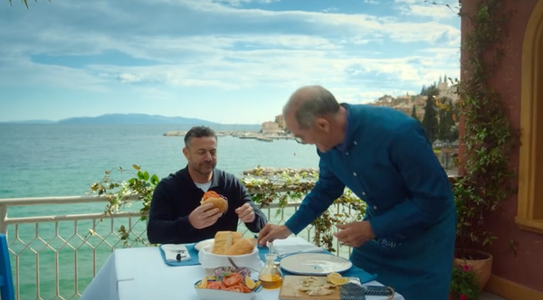 Joe and Gennaro assemble their freshly-caught and cooked fish sandwiches on a balcony overlooking the sea.
