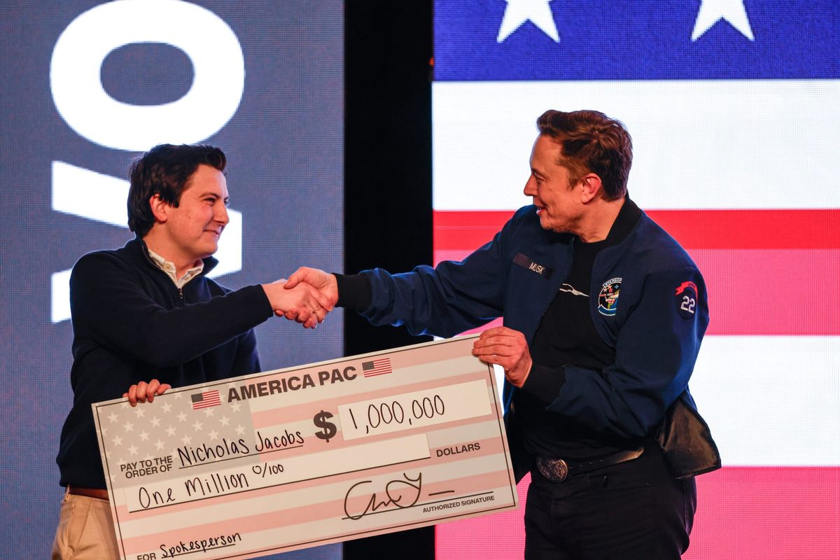 Elon Musk handing a large check for $1 million to a voter in Green Bay.